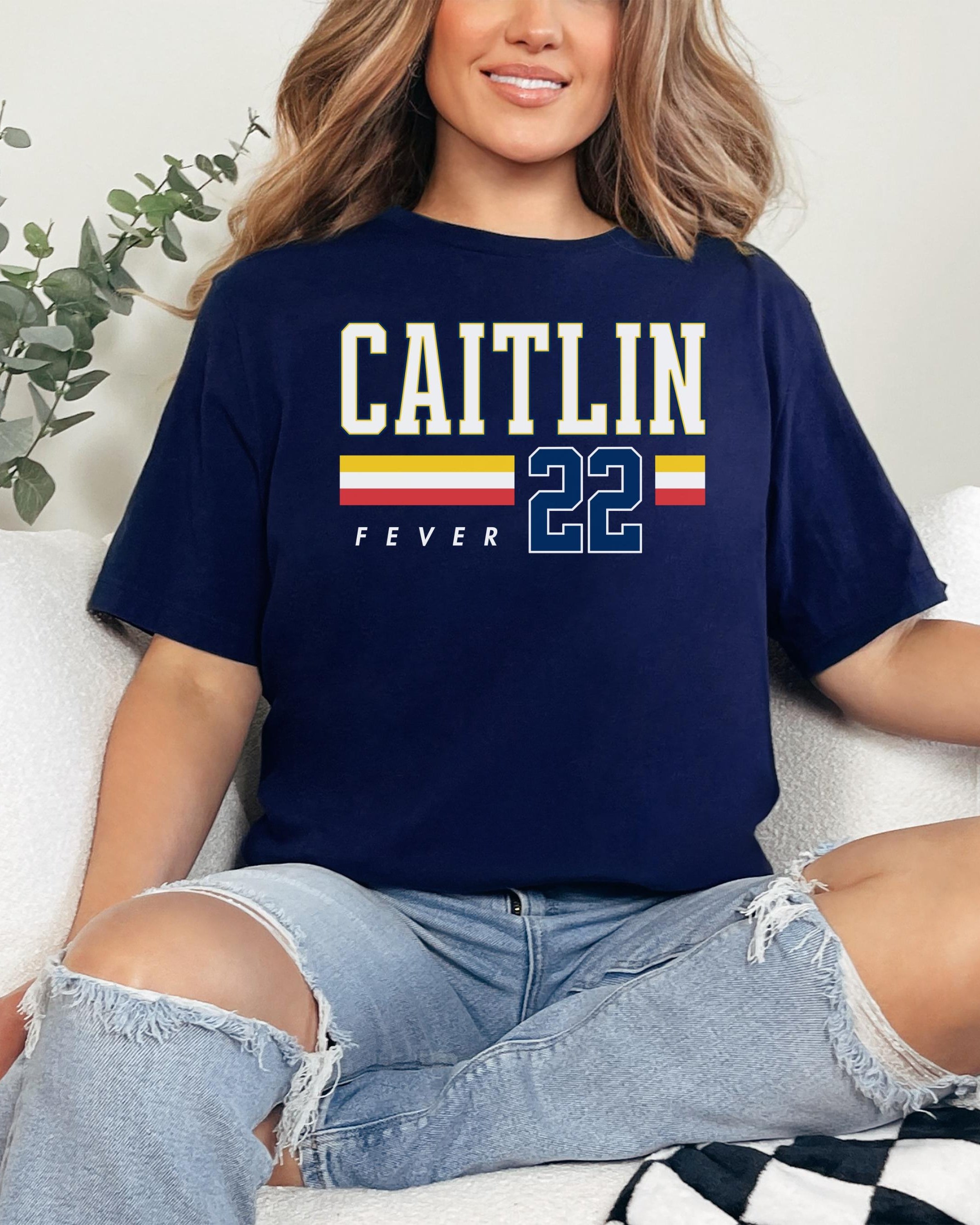 Person wearing t-shirt with 'CAITLIN FEVER' printed on it