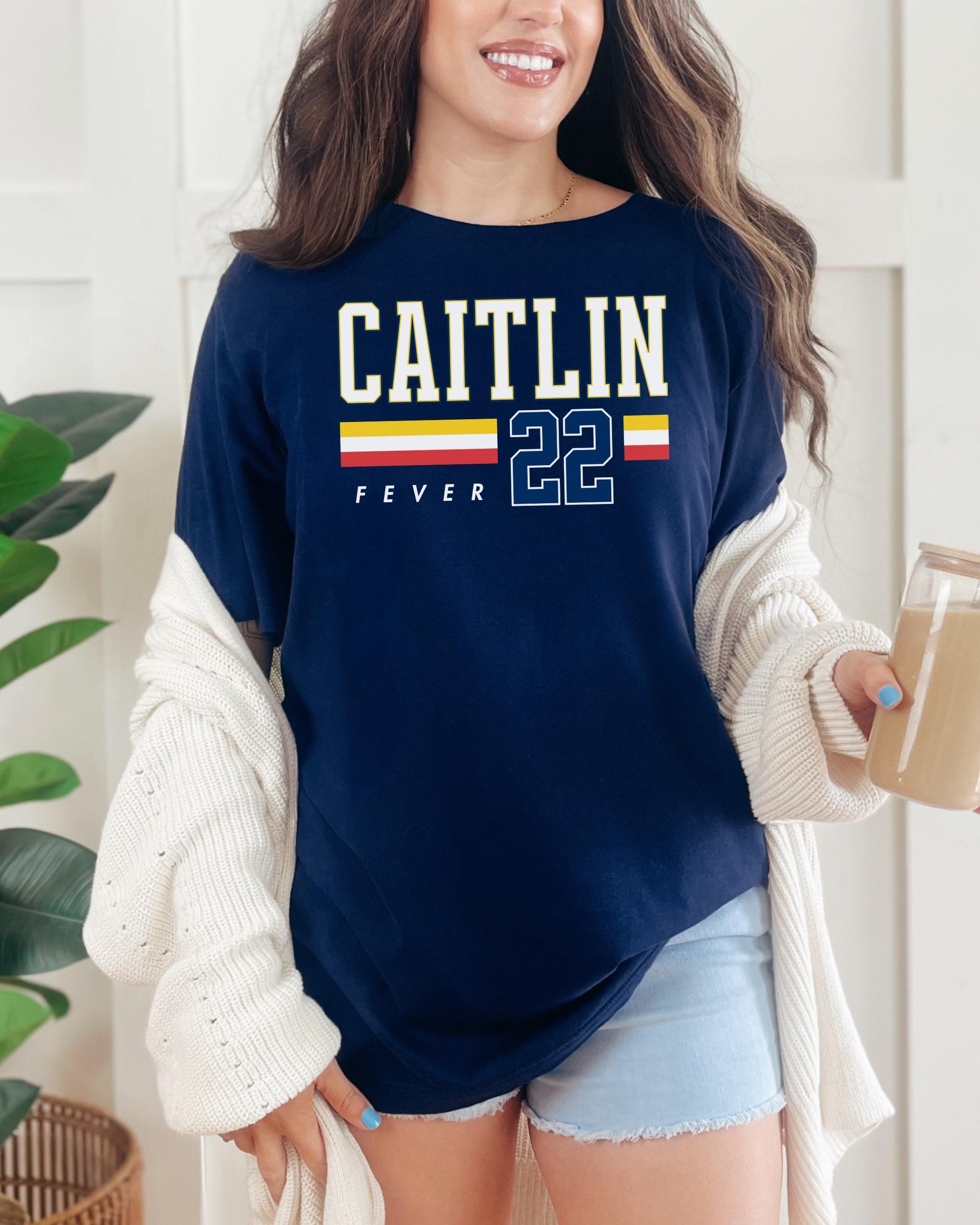 Person wearing t-shirt with 'CAITLIN FEVER' printed on it