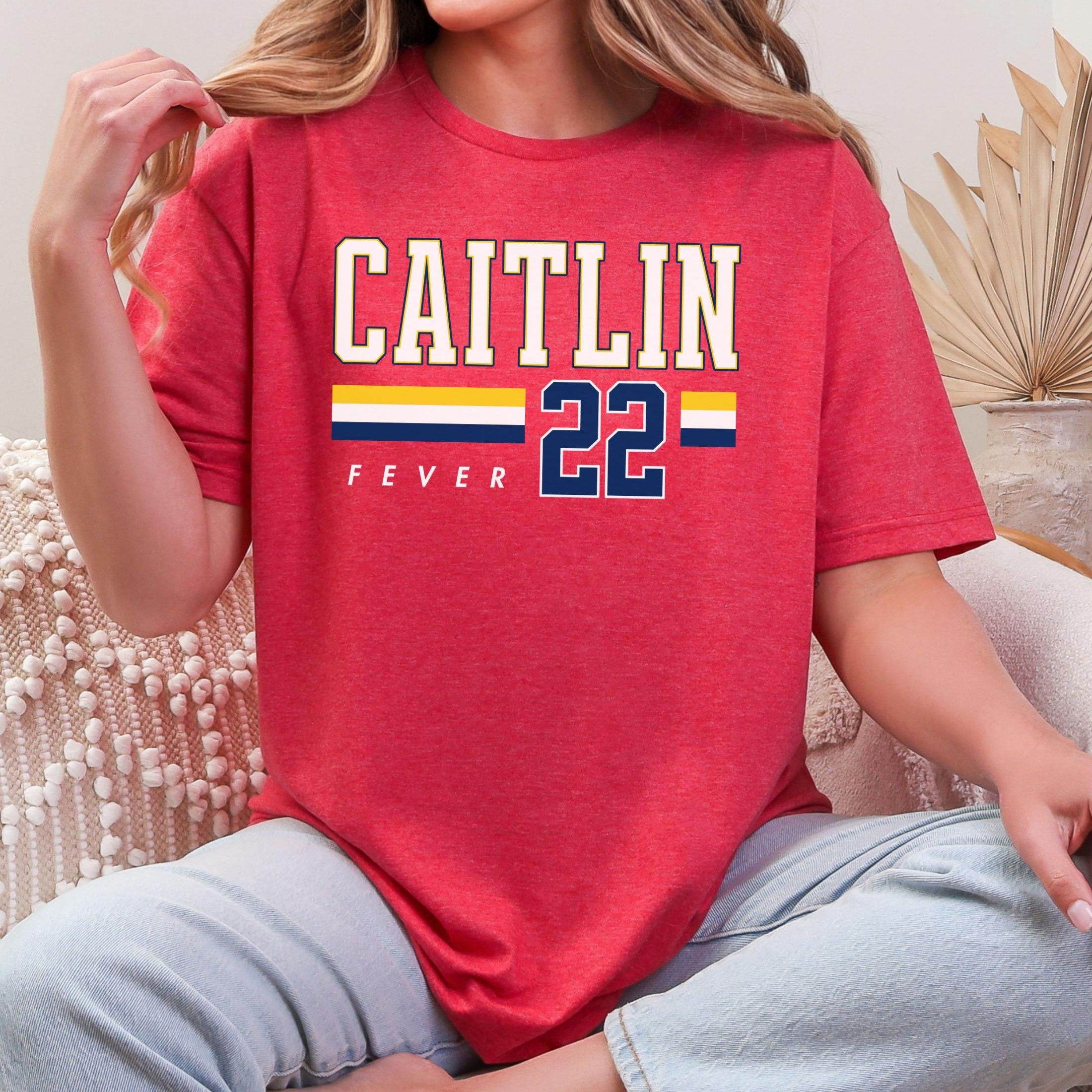 Person wearing t-shirt with 'CAITLIN FEVER' printed on it