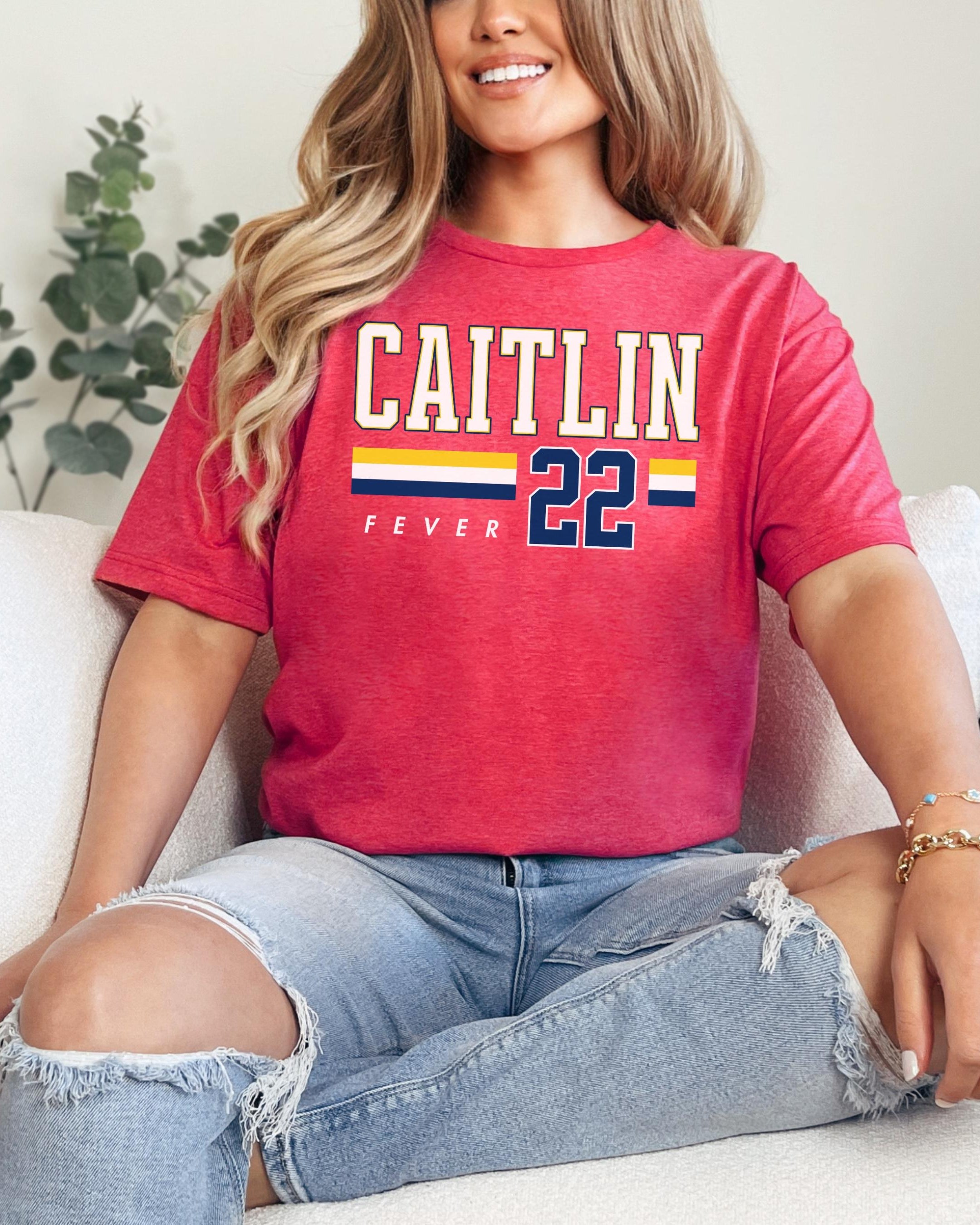 Person wearing t-shirt with 'CAITLIN FEVER' printed on it