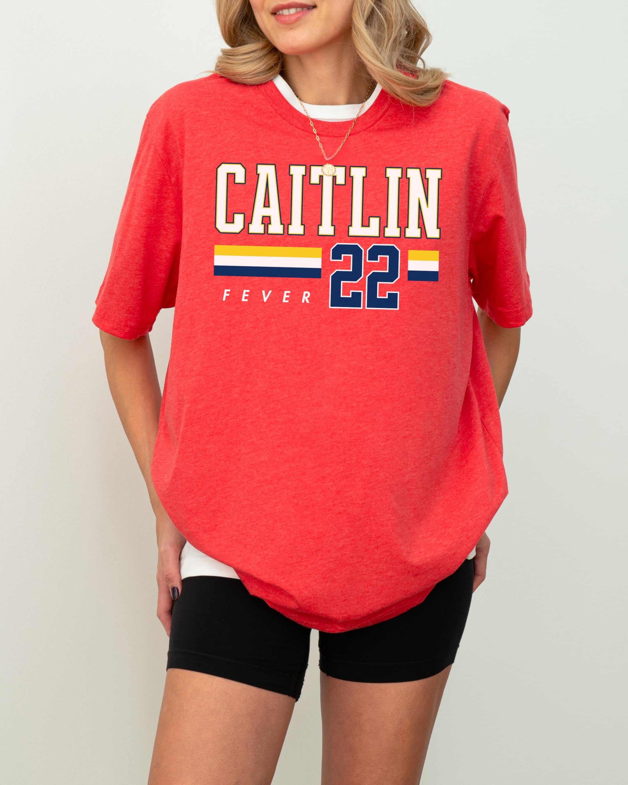Person wearing t-shirt with 'CAITLIN FEVER' printed on it