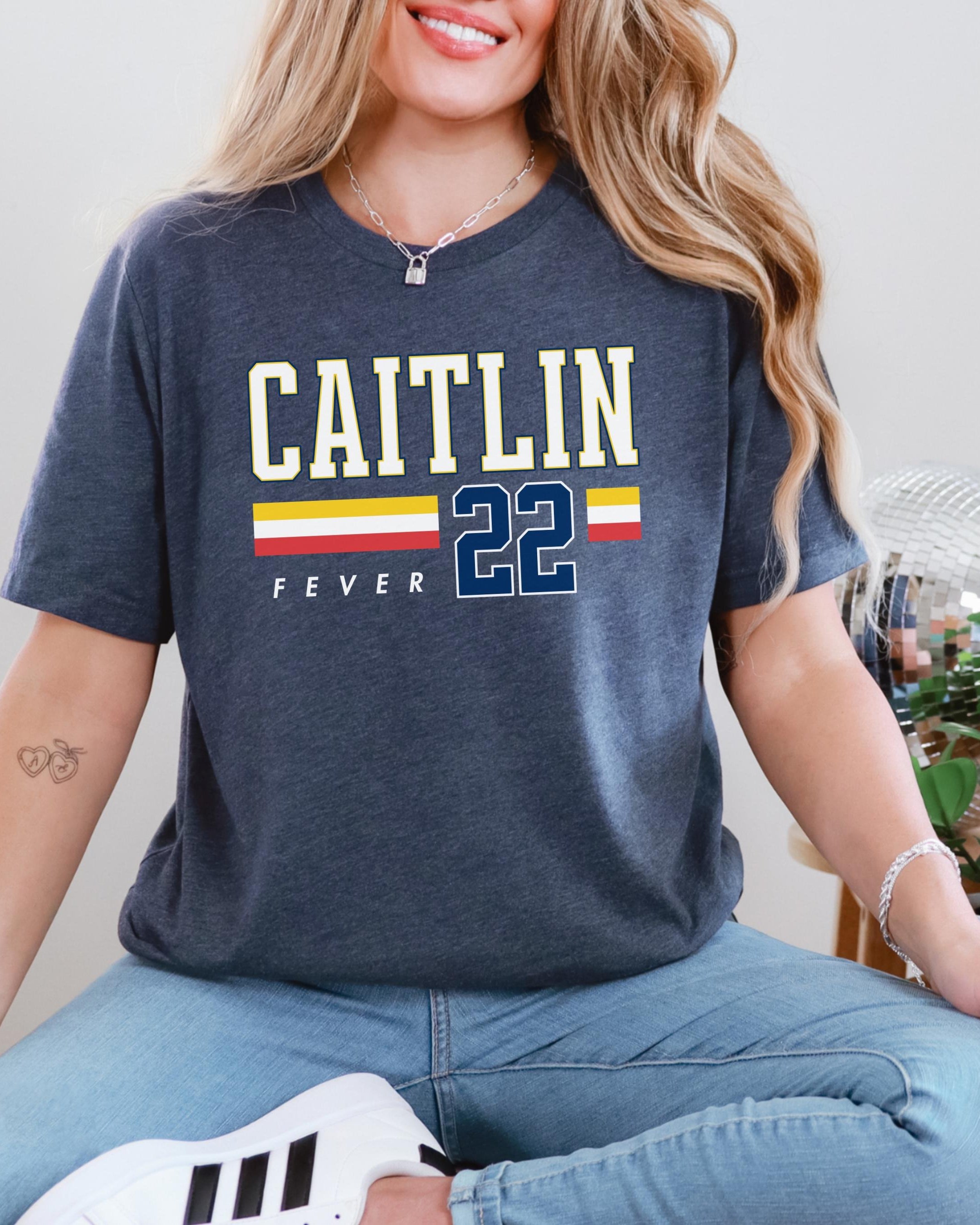 Person wearing t-shirt with 'CAITLIN FEVER' printed on it