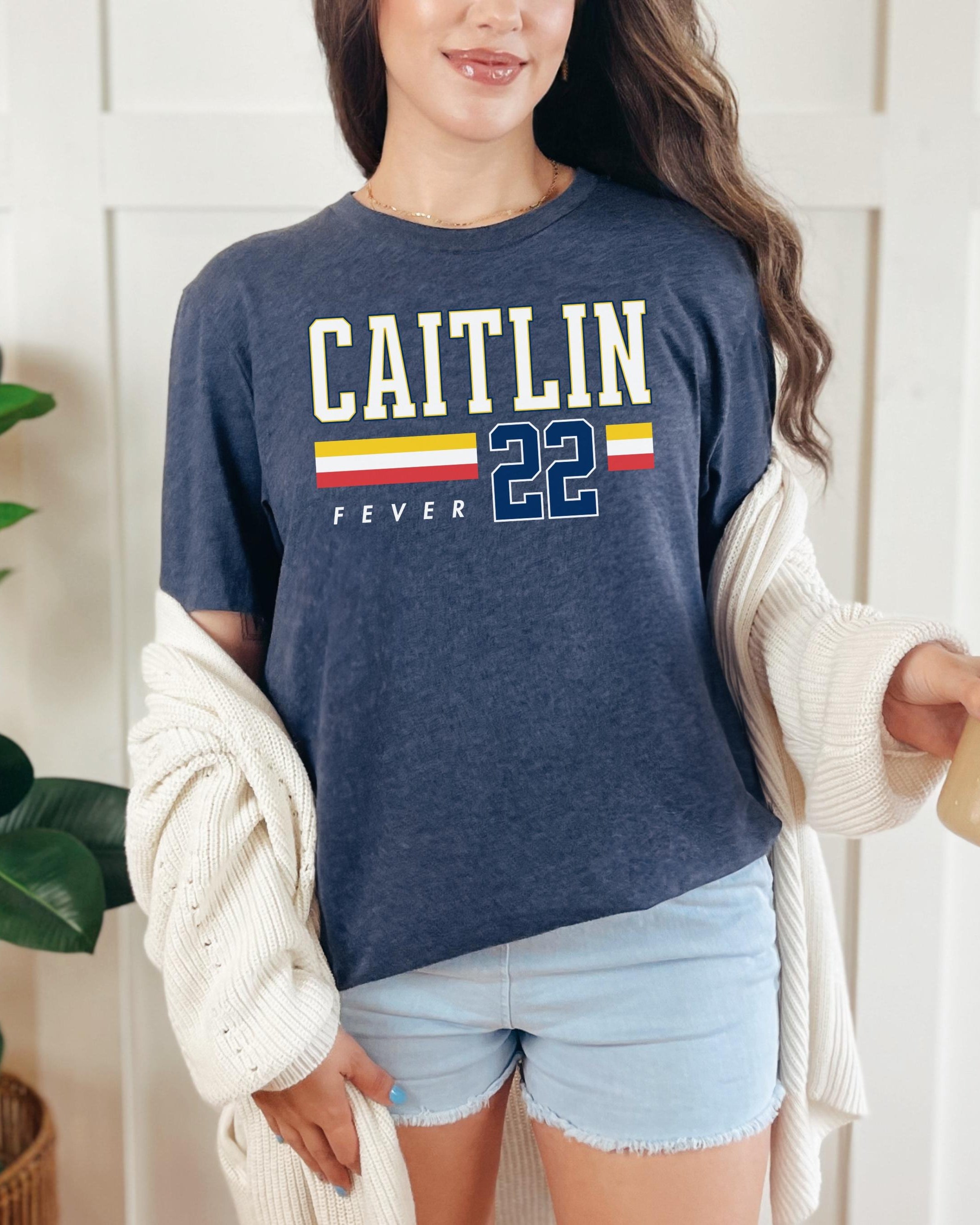 Person wearing t-shirt with 'CAITLIN FEVER' printed on it