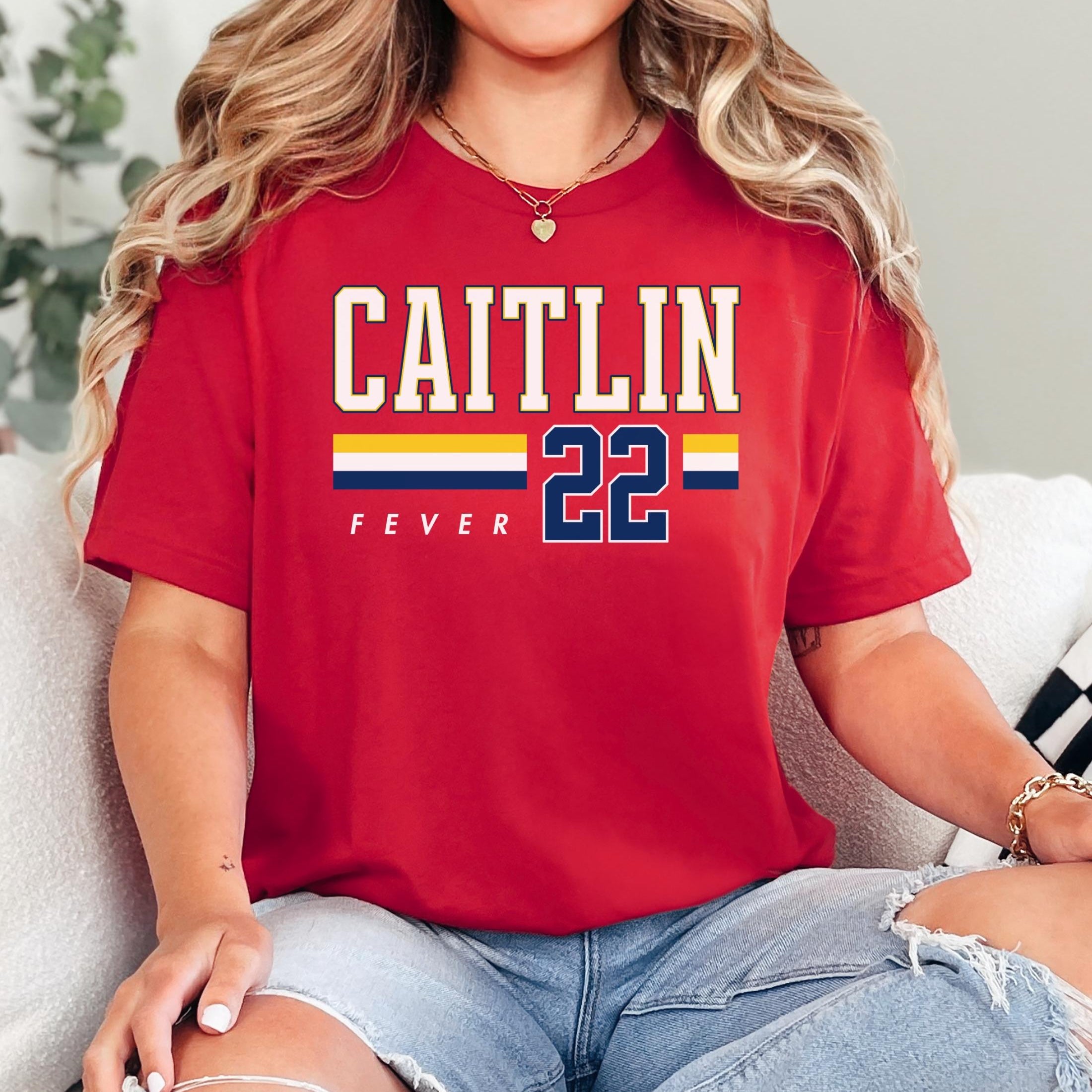 Person wearing t-shirt with 'CAITLIN FEVER' printed on it