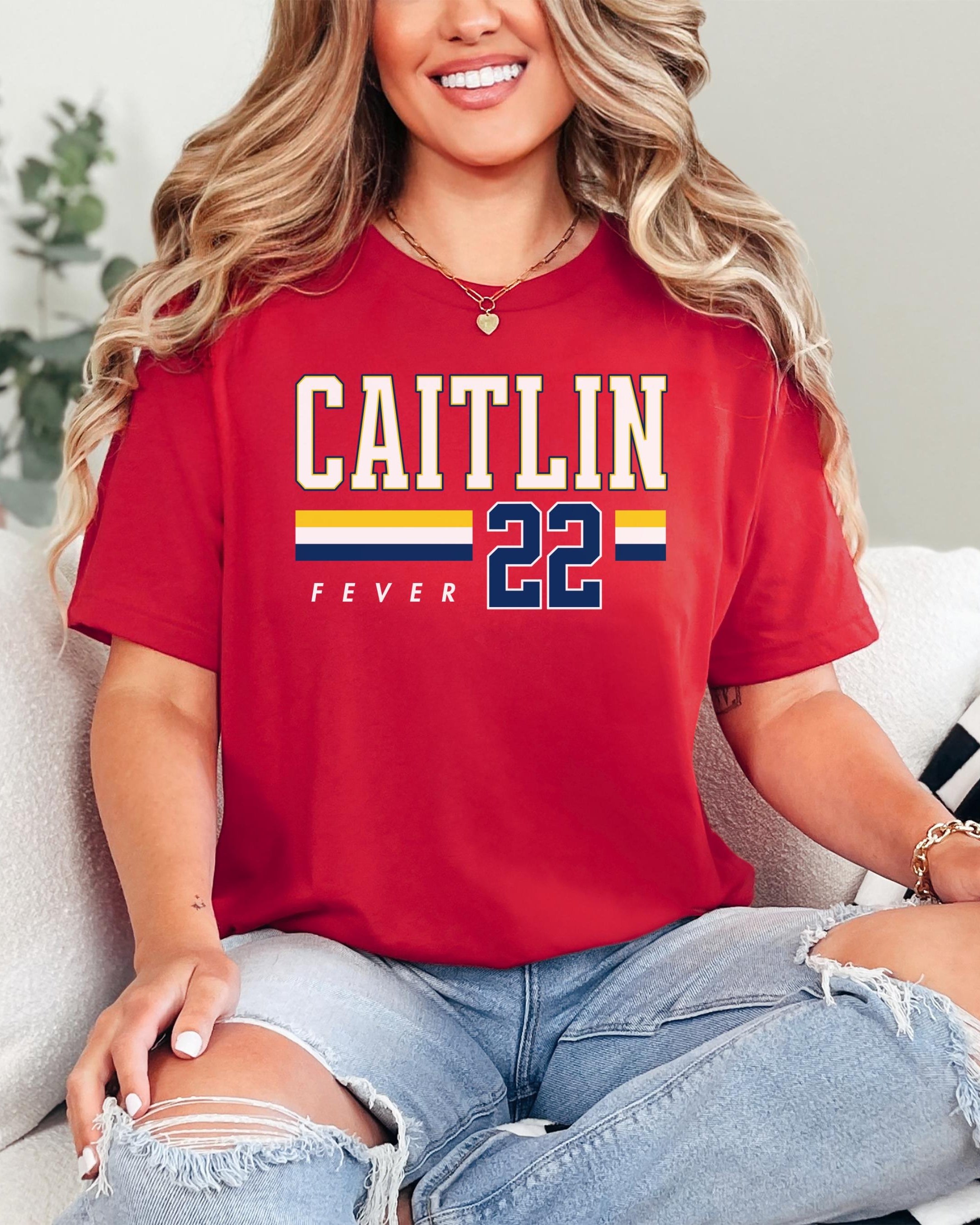 Person wearing t-shirt with 'CAITLIN FEVER' printed on it