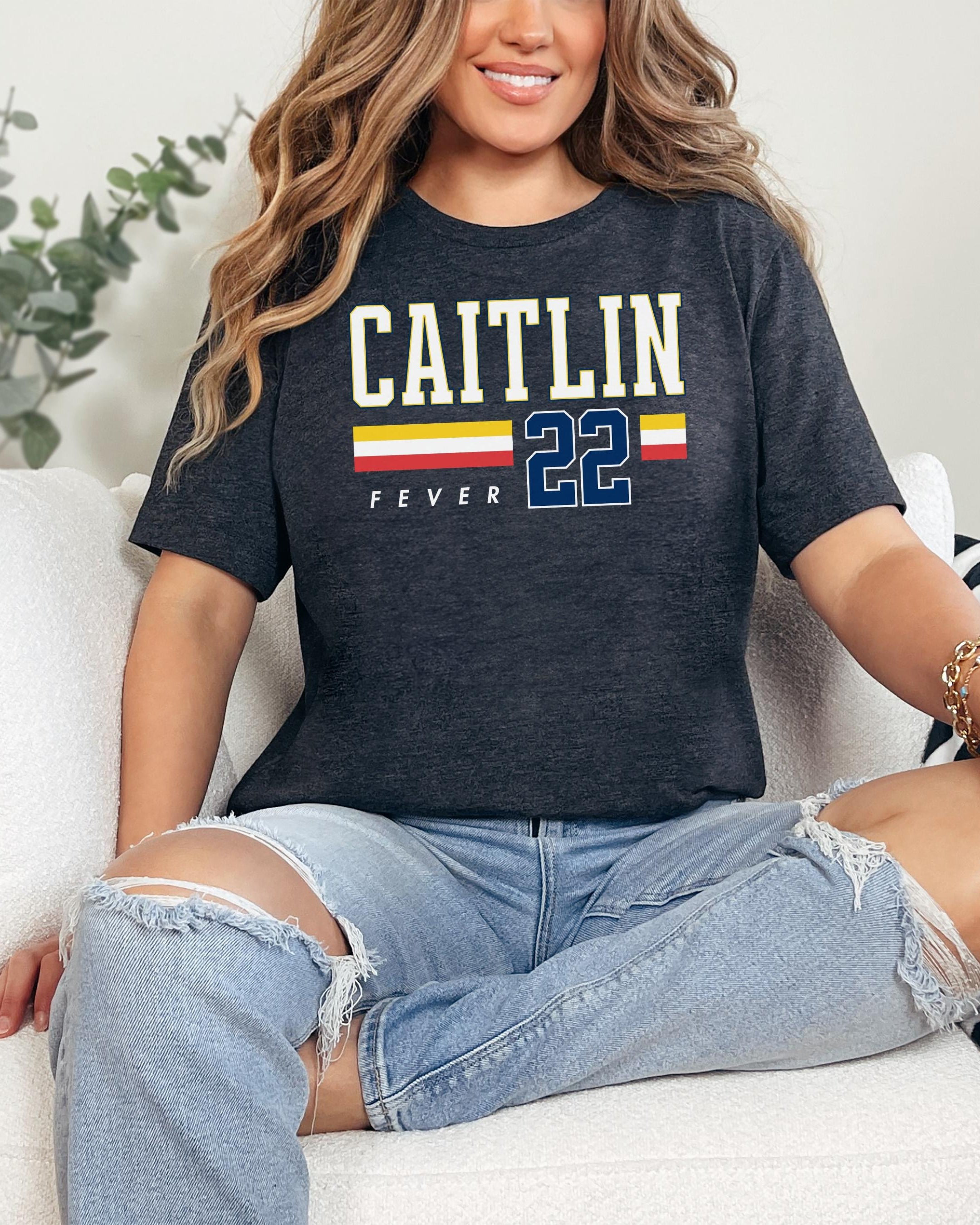Person wearing t-shirt with 'CAITLIN FEVER' printed on it