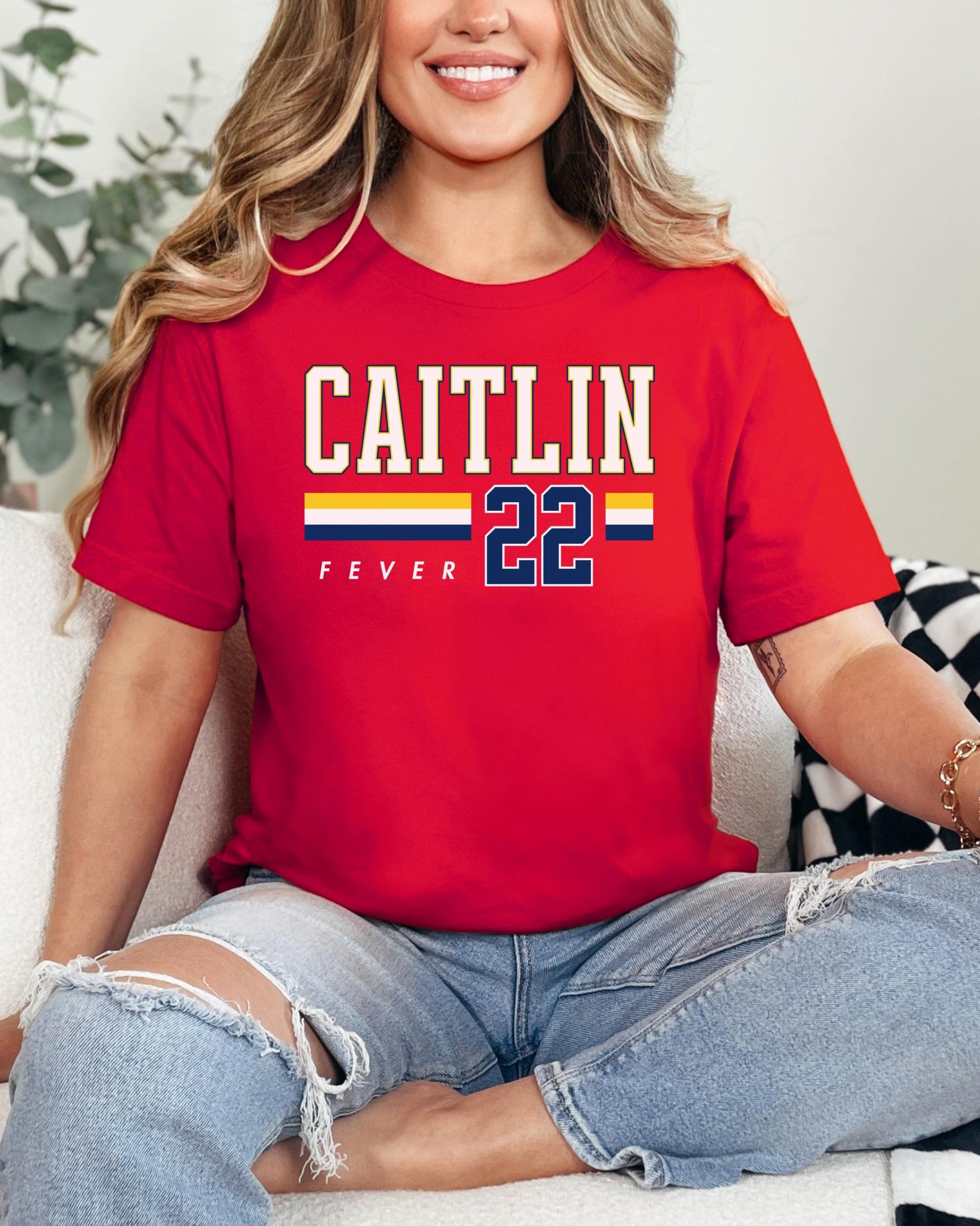 Person wearing t-shirt with 'CAITLIN FEVER' printed on it