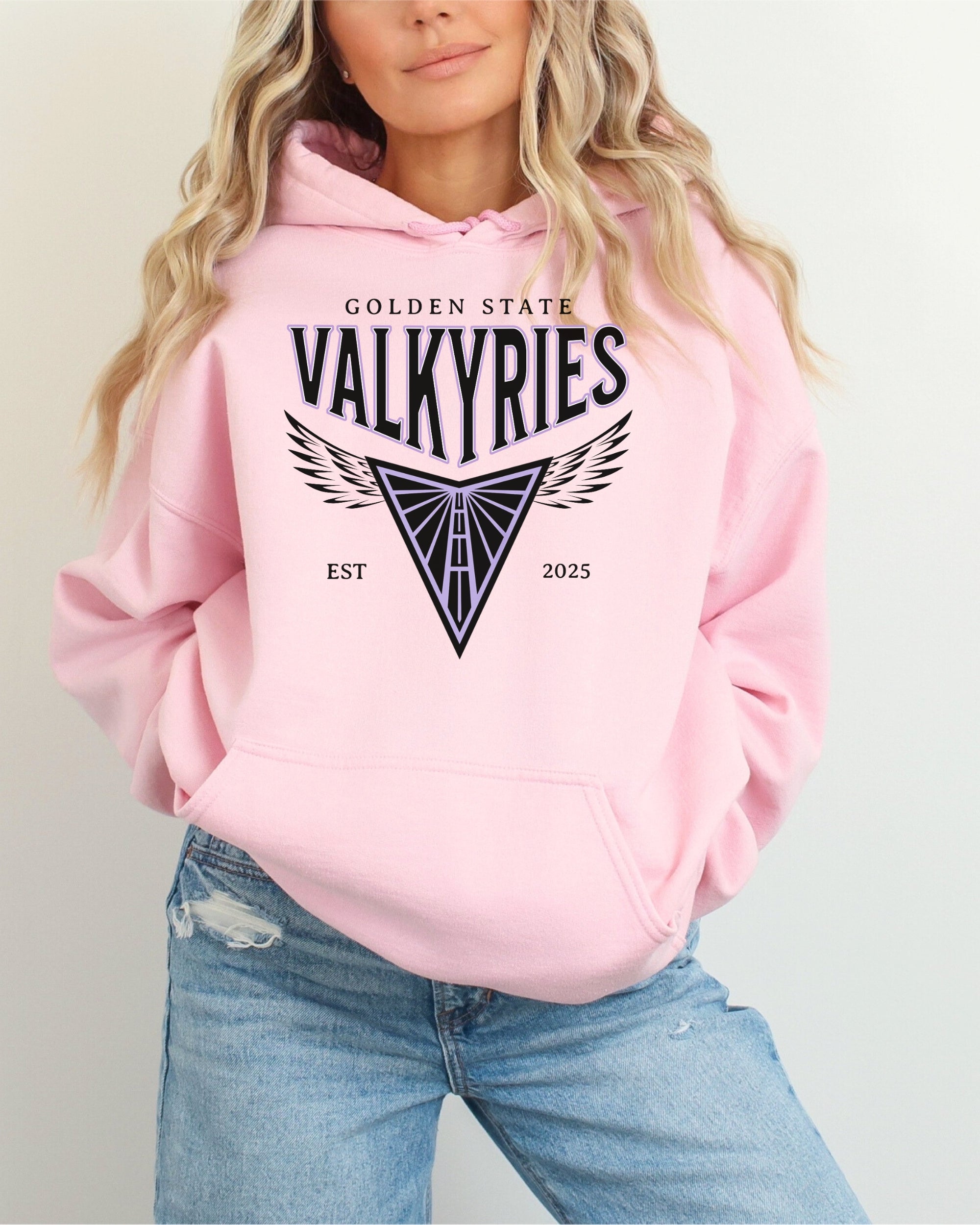 Person wearing a pink hoodie with 'Golden State Valkyries' logo on a plain background