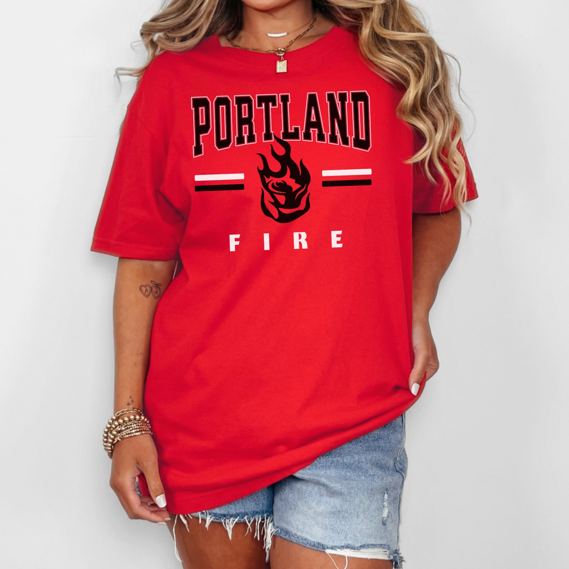 Person wearing a red 'Portland Fire' t-shirt on a white background