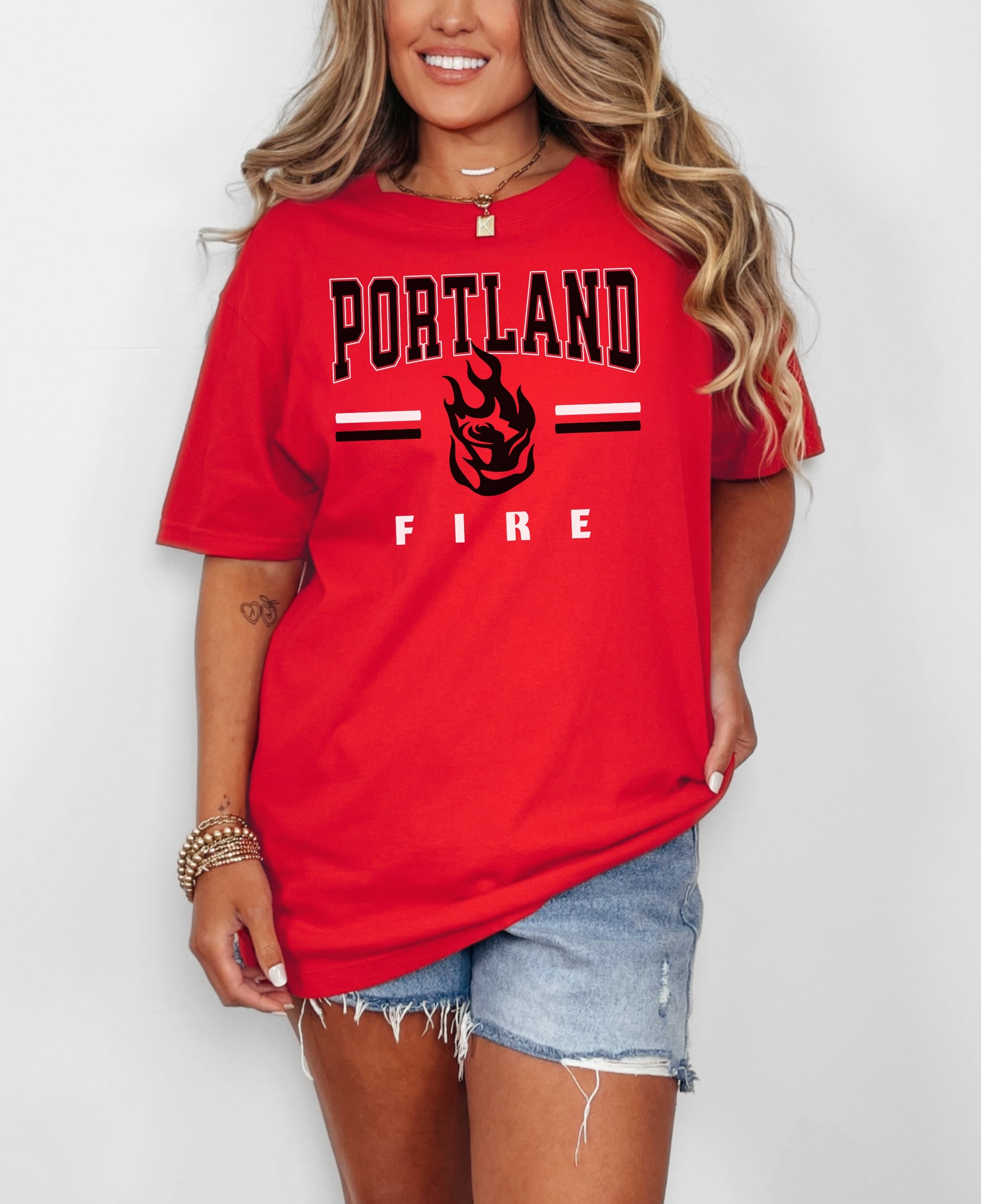 Person wearing a red 'Portland Fire' t-shirt on a white background
