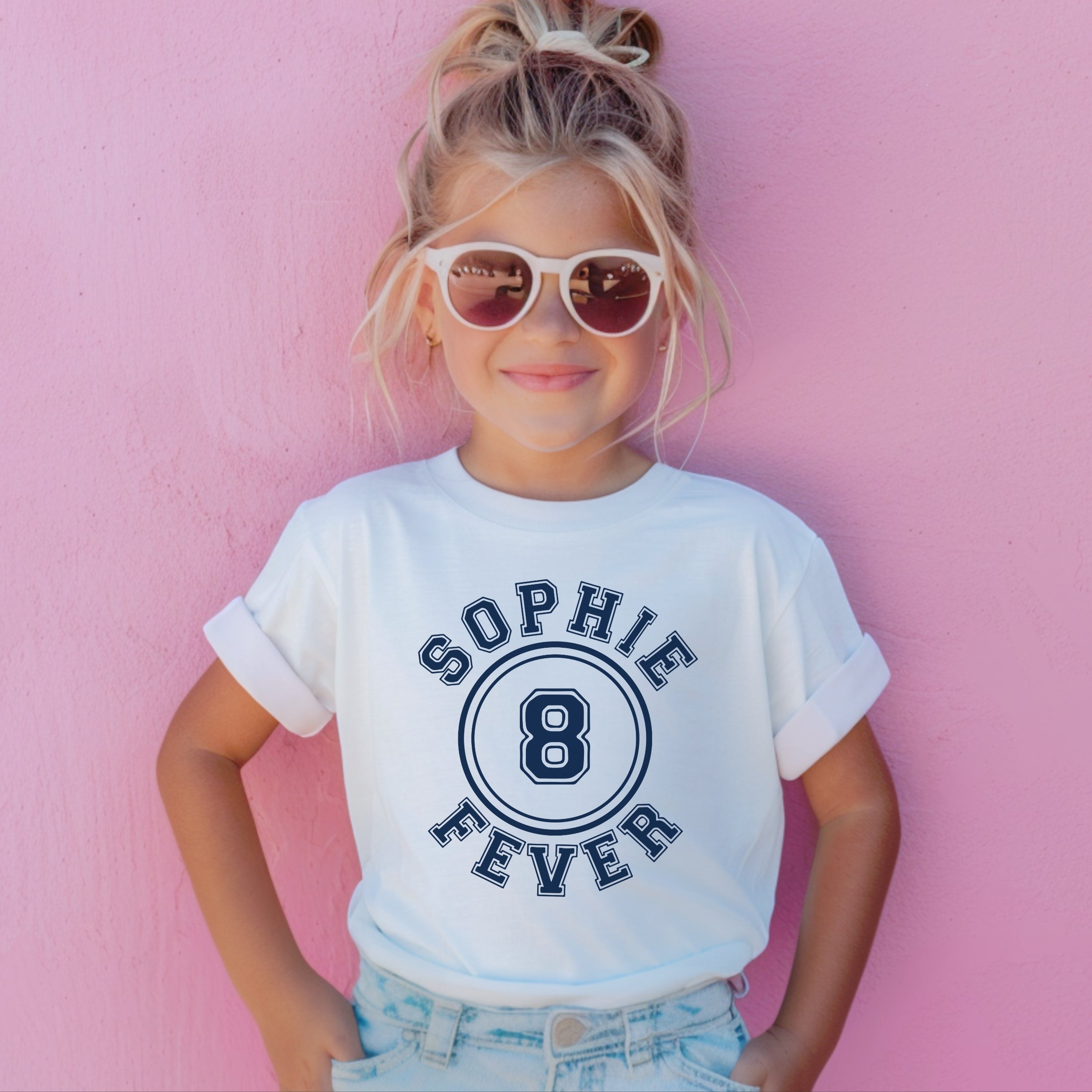 Child wearing a white t-shirt with 'Sophie 8 Fever' design against a pink background
