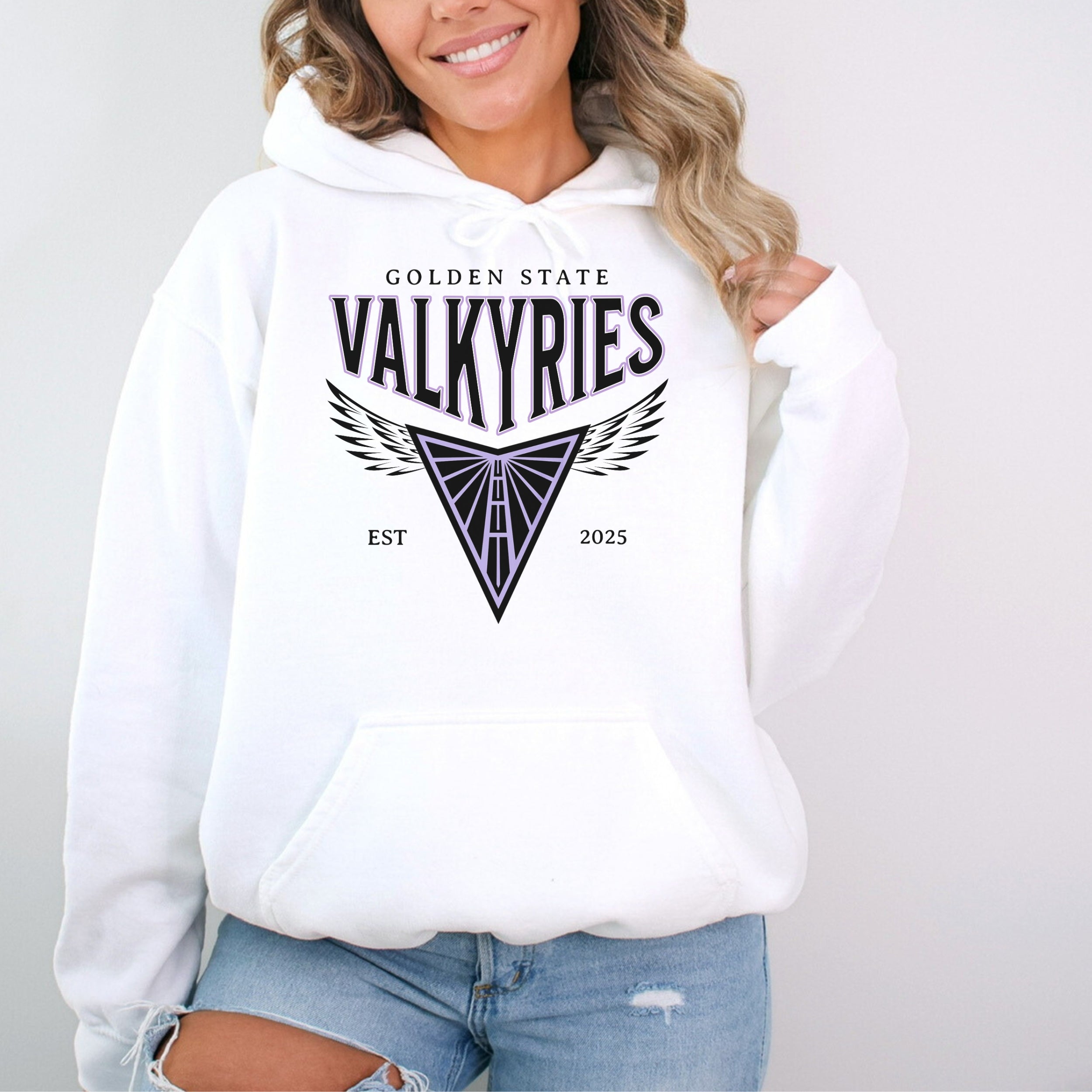 Person wearing a white hoodie with 'Golden State Valkyries' text and logo on a plain background