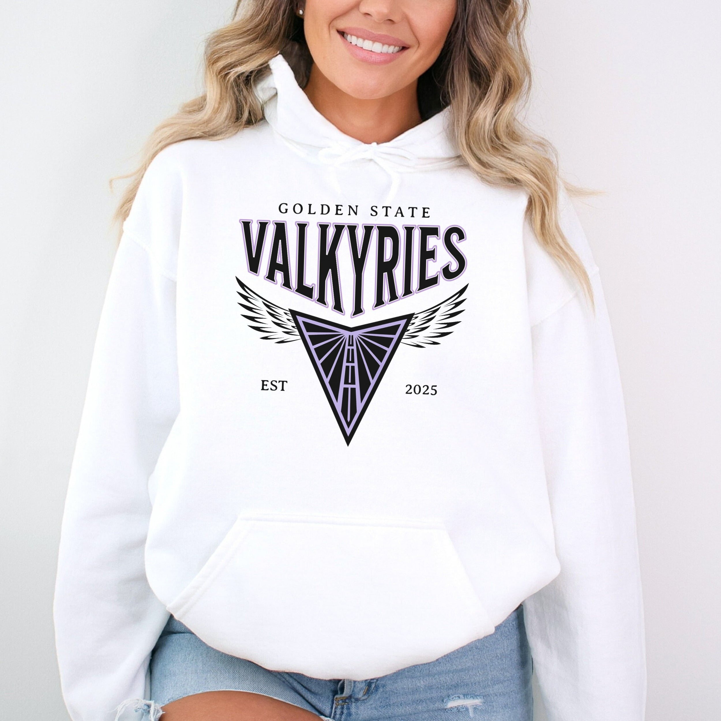 Person wearing a white hoodie with 'Golden State Valkyries' logo on a plain background