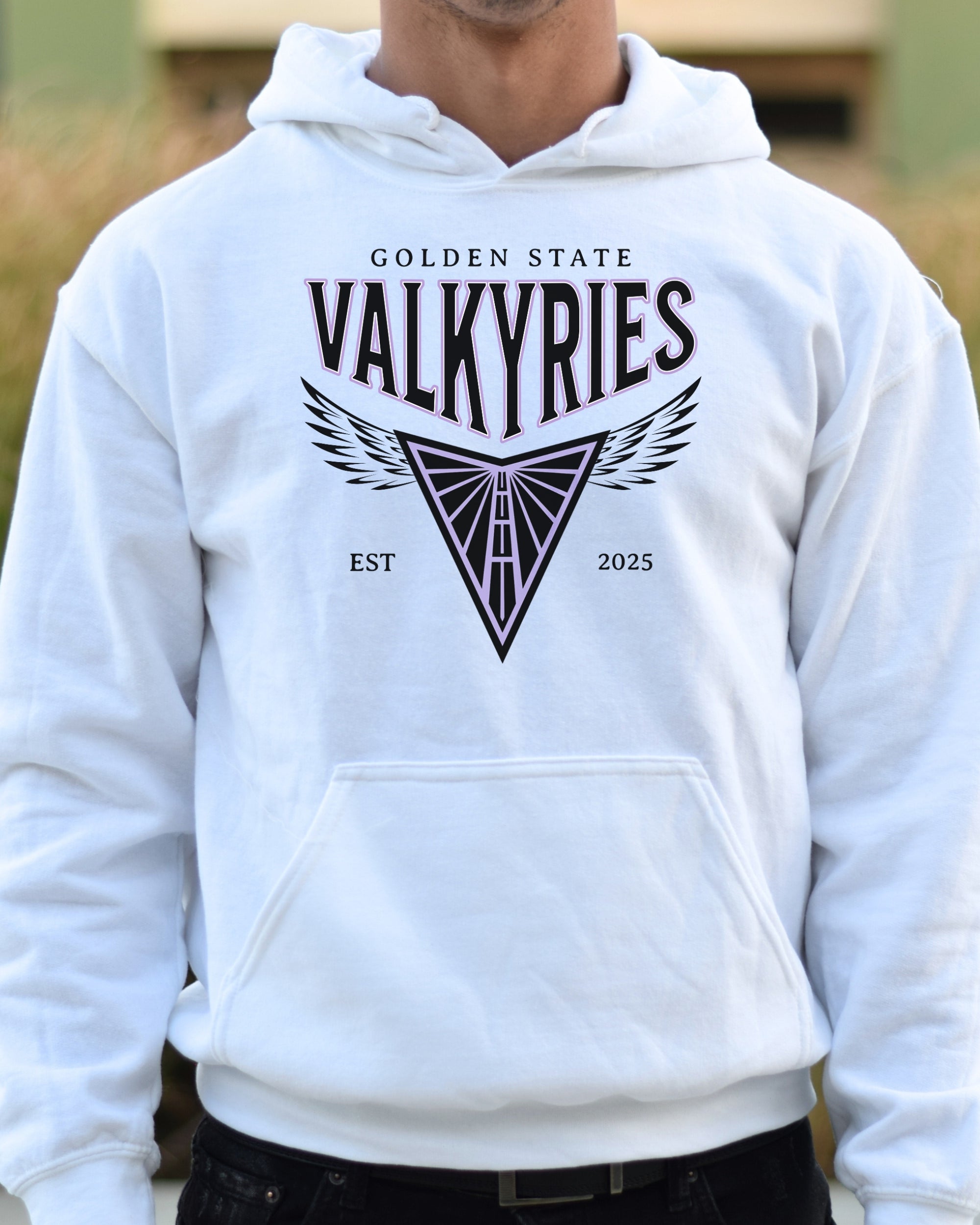 White hoodie with 'Golden State Valkyries' design on a blurred outdoor background