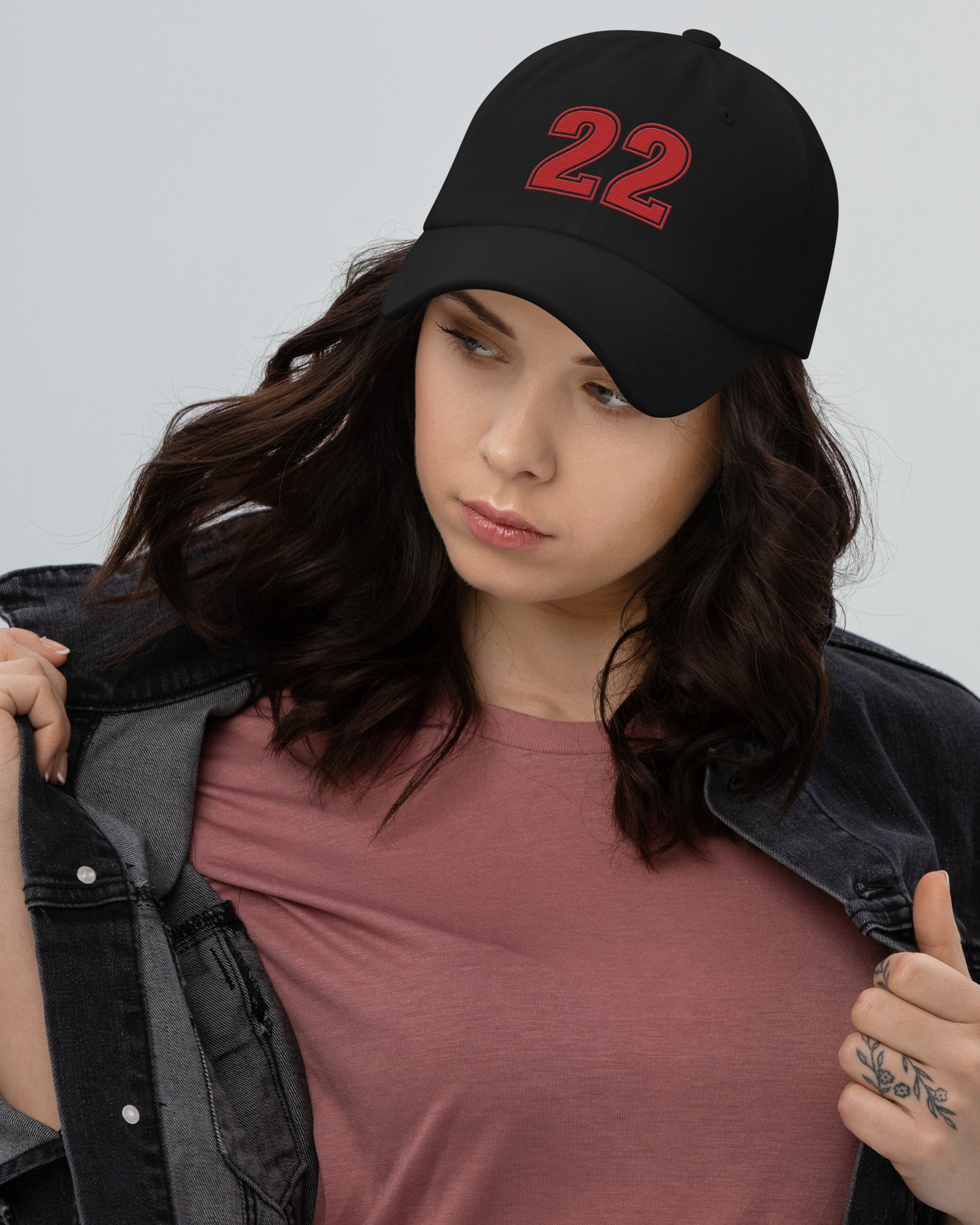 Girl wearing black number 22 dad hat