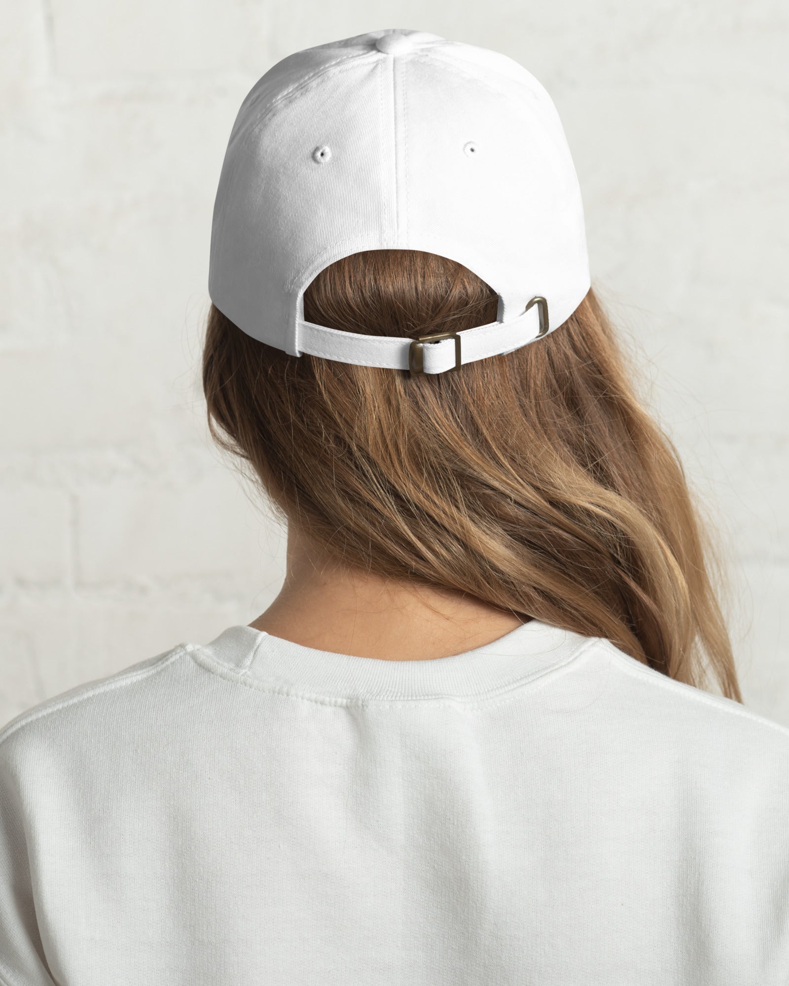Back of girl wearing white dad hat