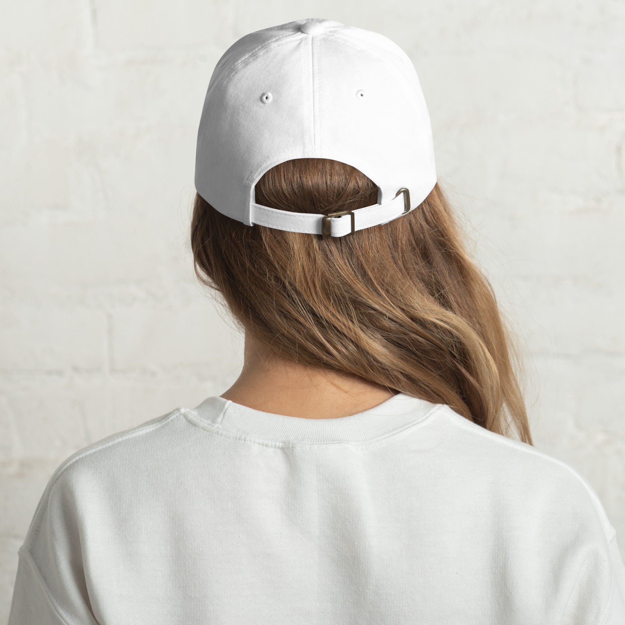 Back of girl wearing white dad hat