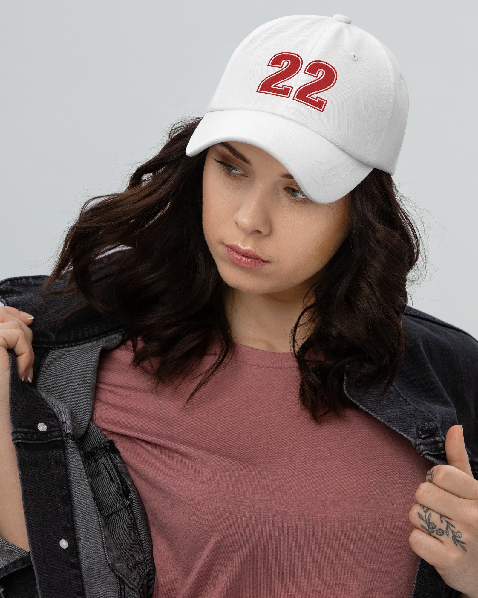 Girl wearing white number 22 dad hat