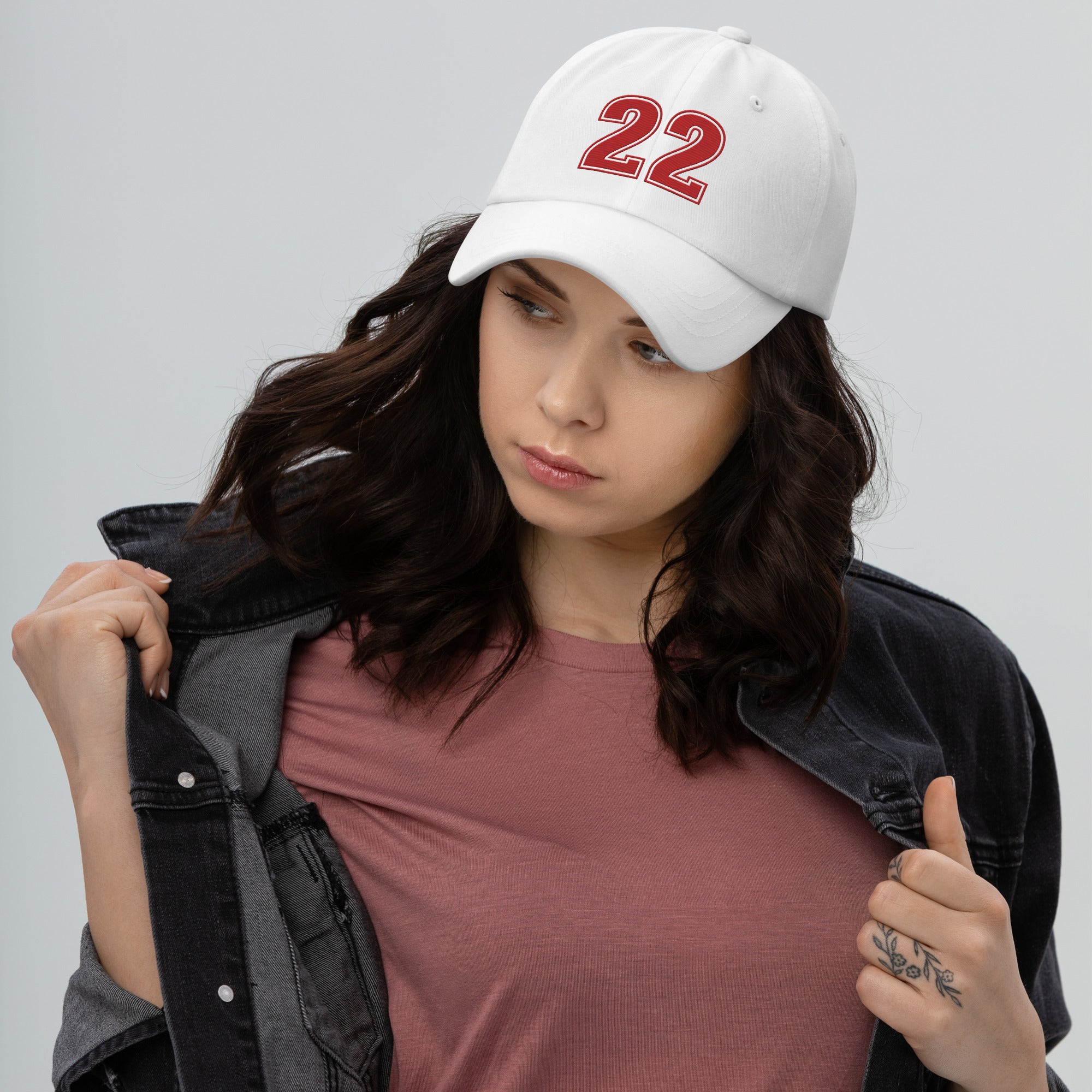Girl wearing white number 22 dad hat