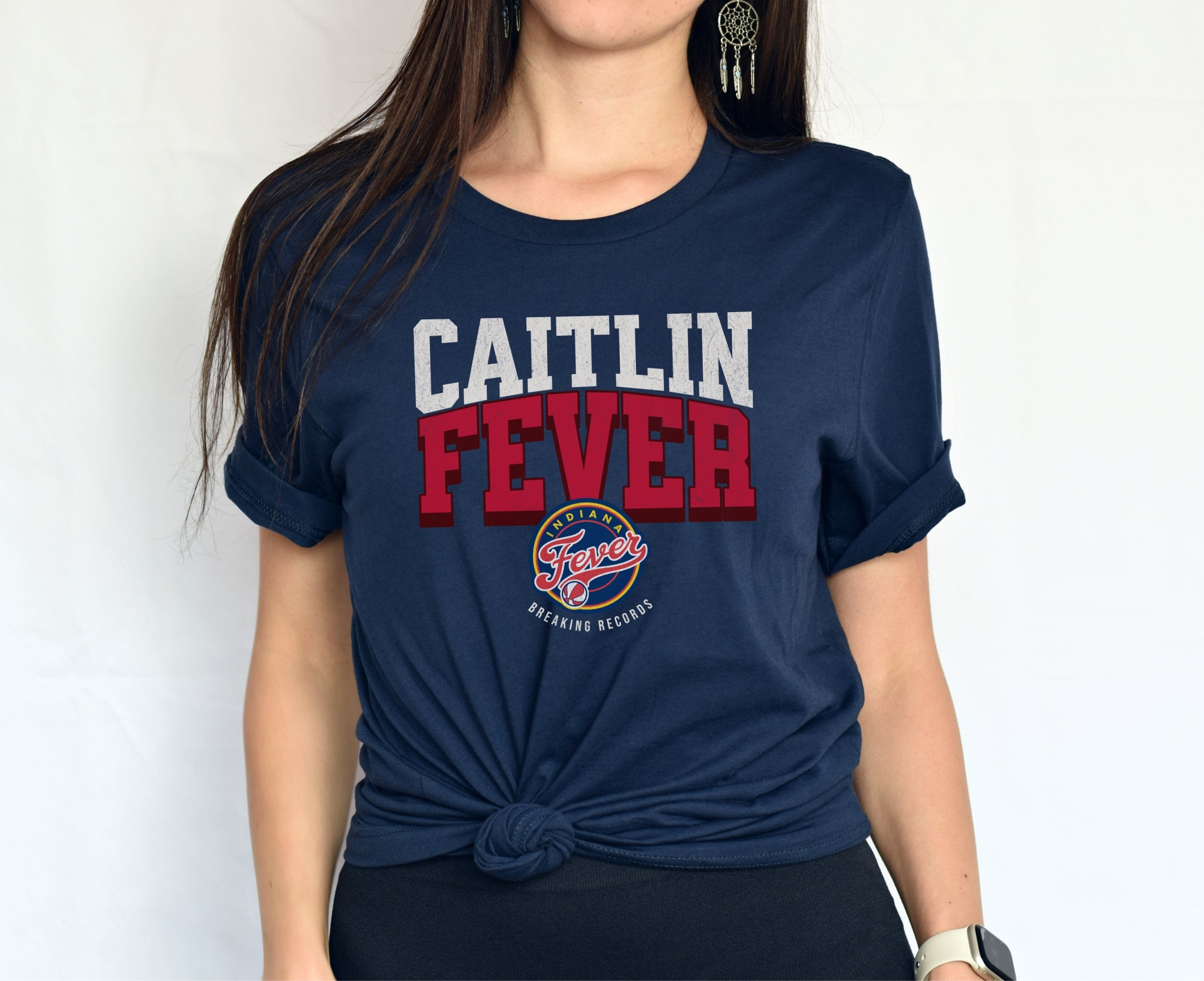 Woman wearing navy Caitlin Fever shirt