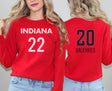 Girl wearing red sweatshirt with Indiana 22 on front and Valkyries 20 on back