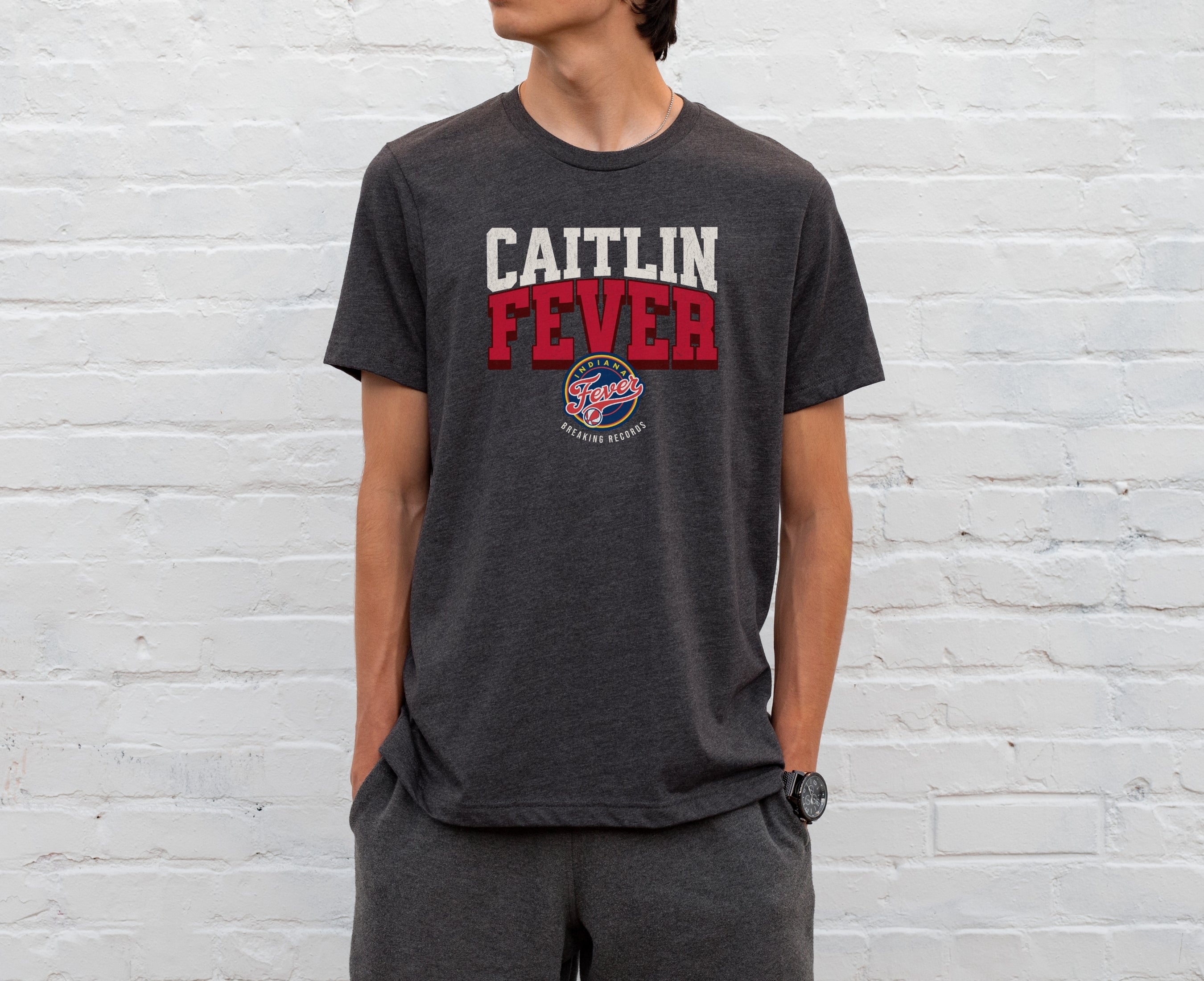 Man wearing dark grey heather Caitlin Fever shirt