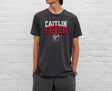 Man wearing dark grey heather Caitlin Fever shirt