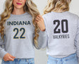 Girl wearing sport grey sweatshirt with Indiana 22 on front and Valkyries 20 on back