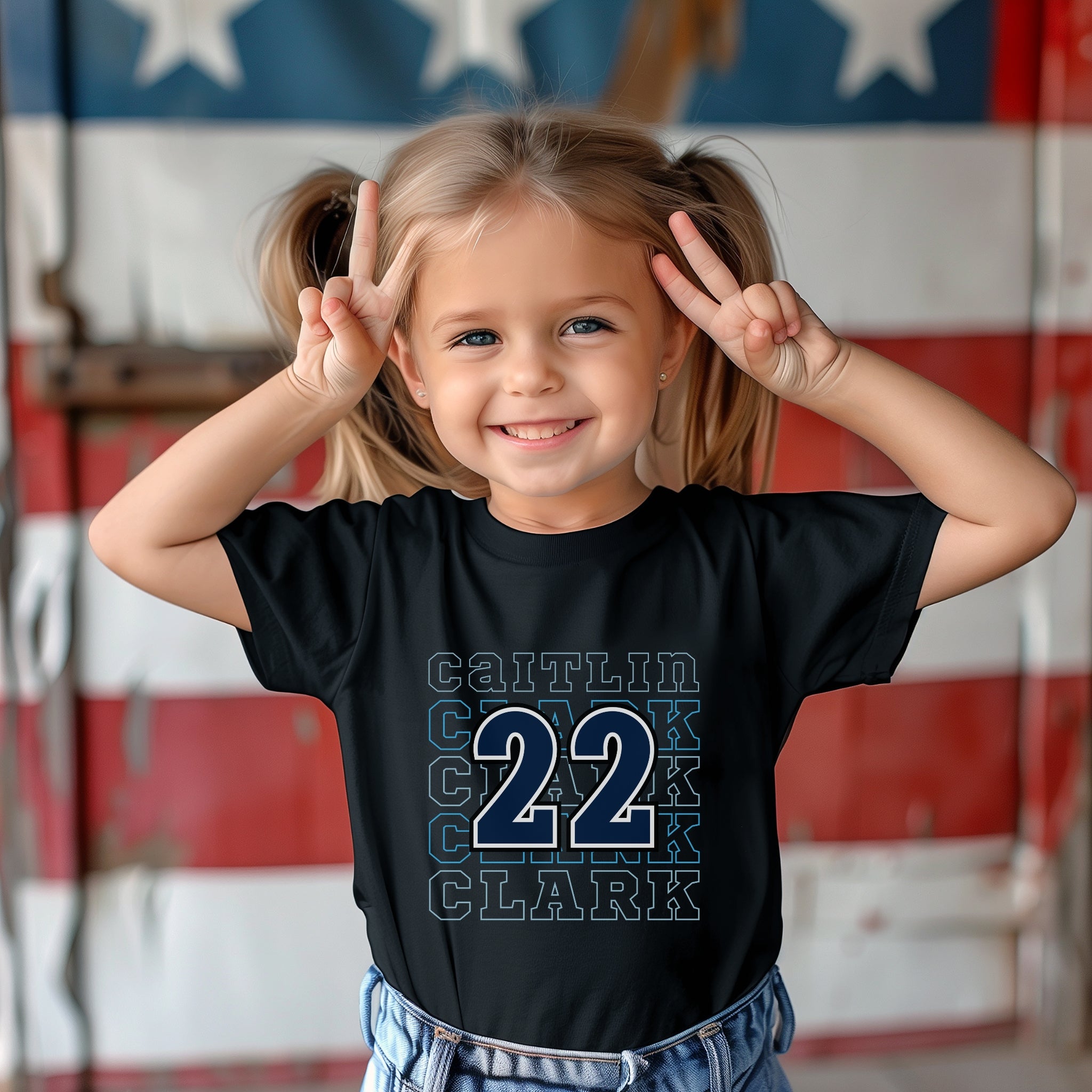 Little girl wearing black Caitlin Clark 22 Toddler Tee