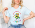 Woman wearing heather ice blue - color the world in kindness shirt