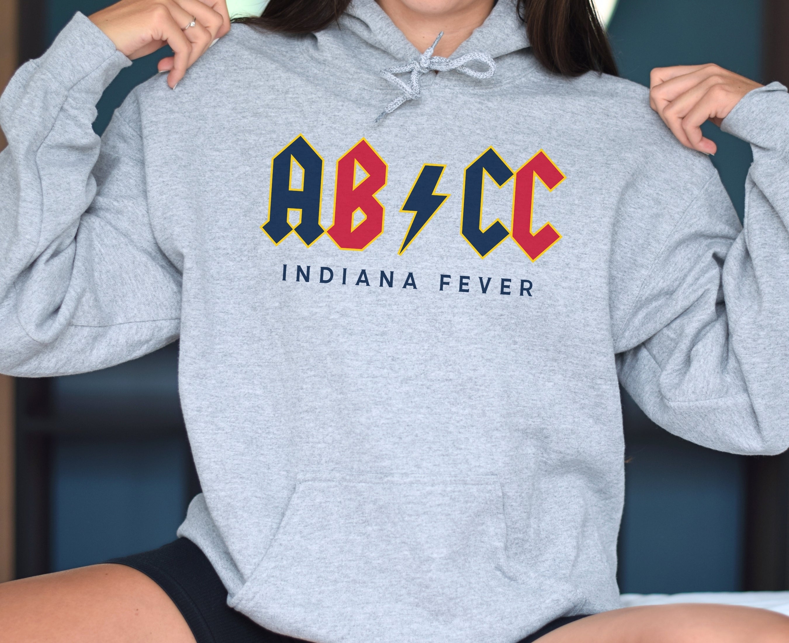 Woman wearing athletic heather ABCC hoodie