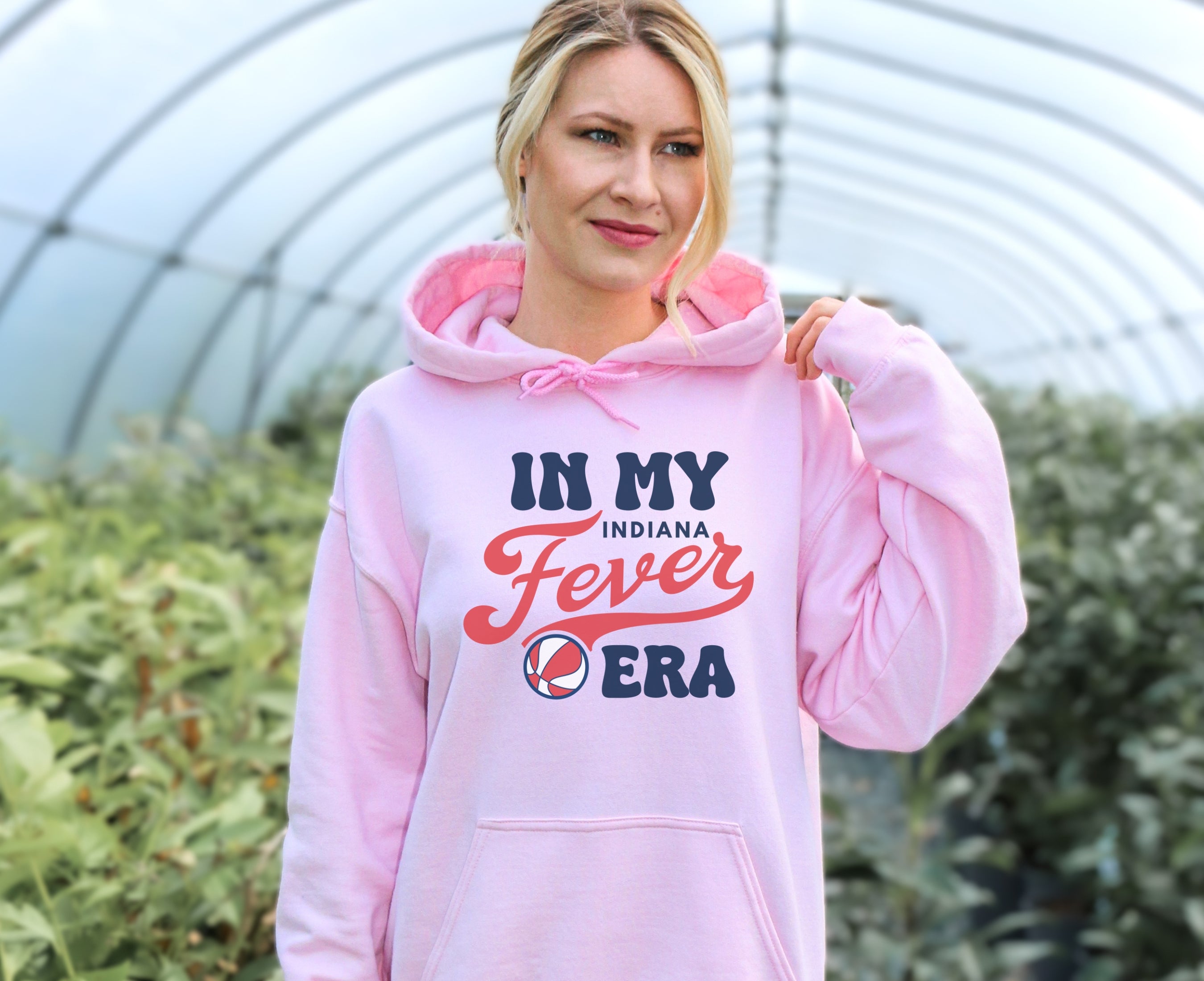 Girl wearing light pink in my Fever era hoodie