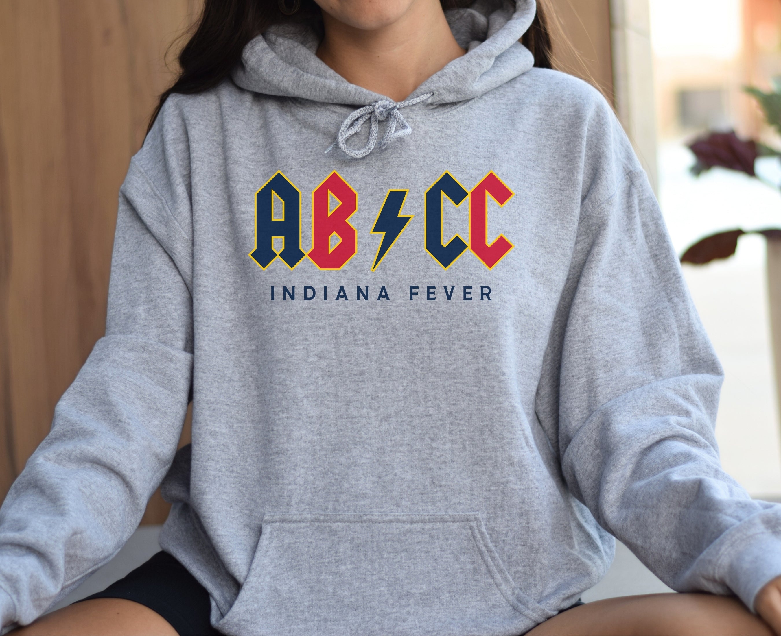 Girl wearing athletic heather Aliyah Boston Caitlin Clark hoodie