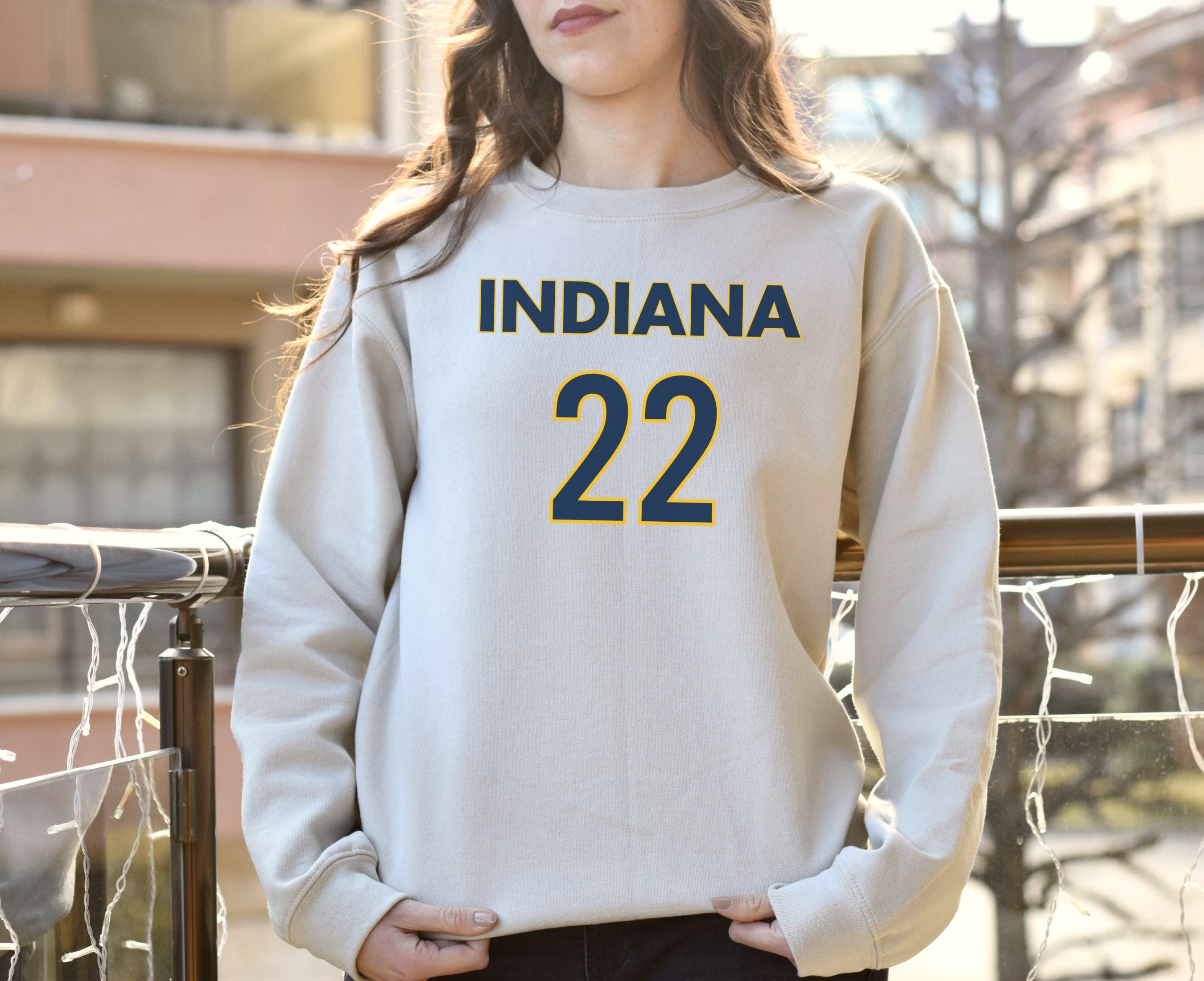 Girl wearing sand Indiana 22 Caitlin Clark sweatshirt