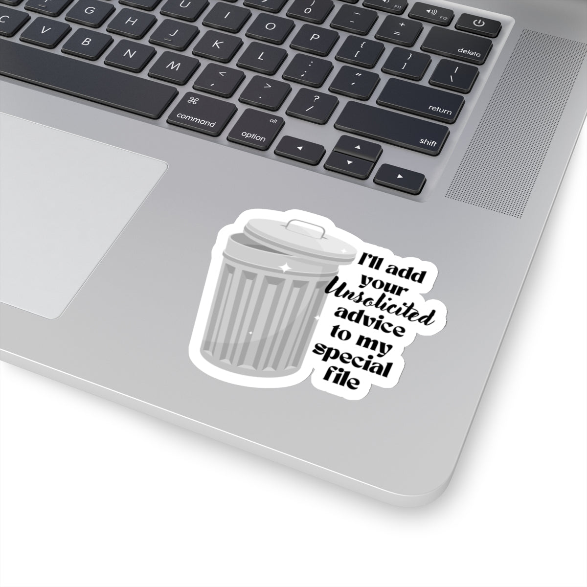 3 inch sticker of a trash can stuck on a laptop