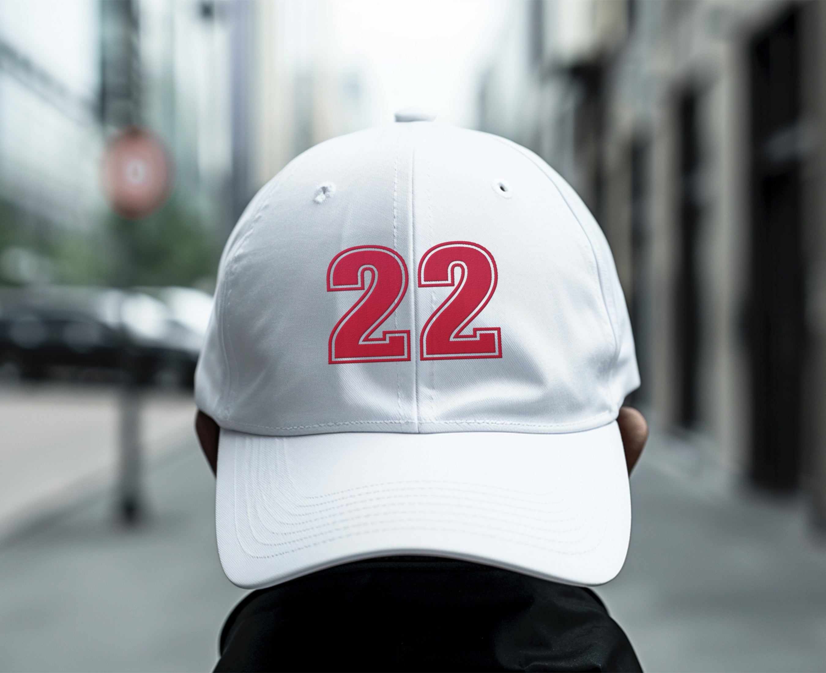 Man wearing white number 22 dad hat backwards