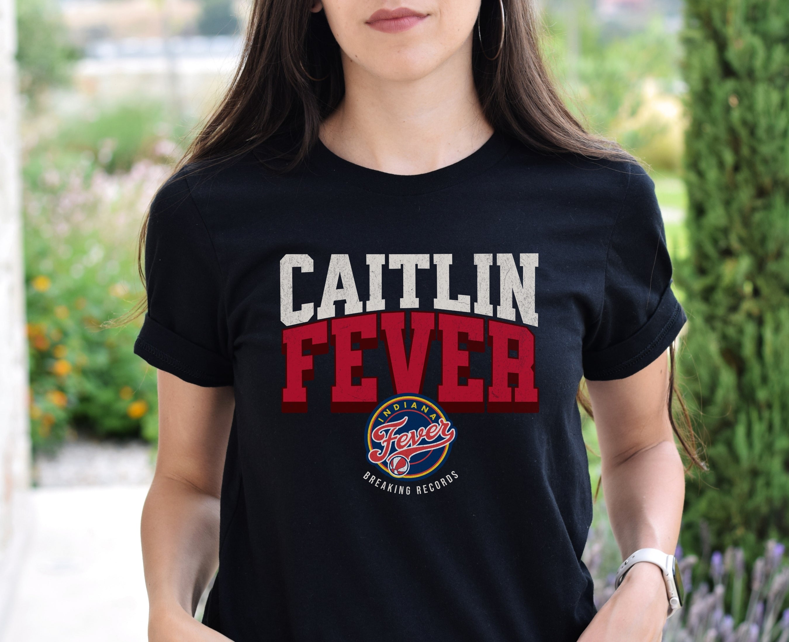 Woman wearing Black Caitlin Fever shirt