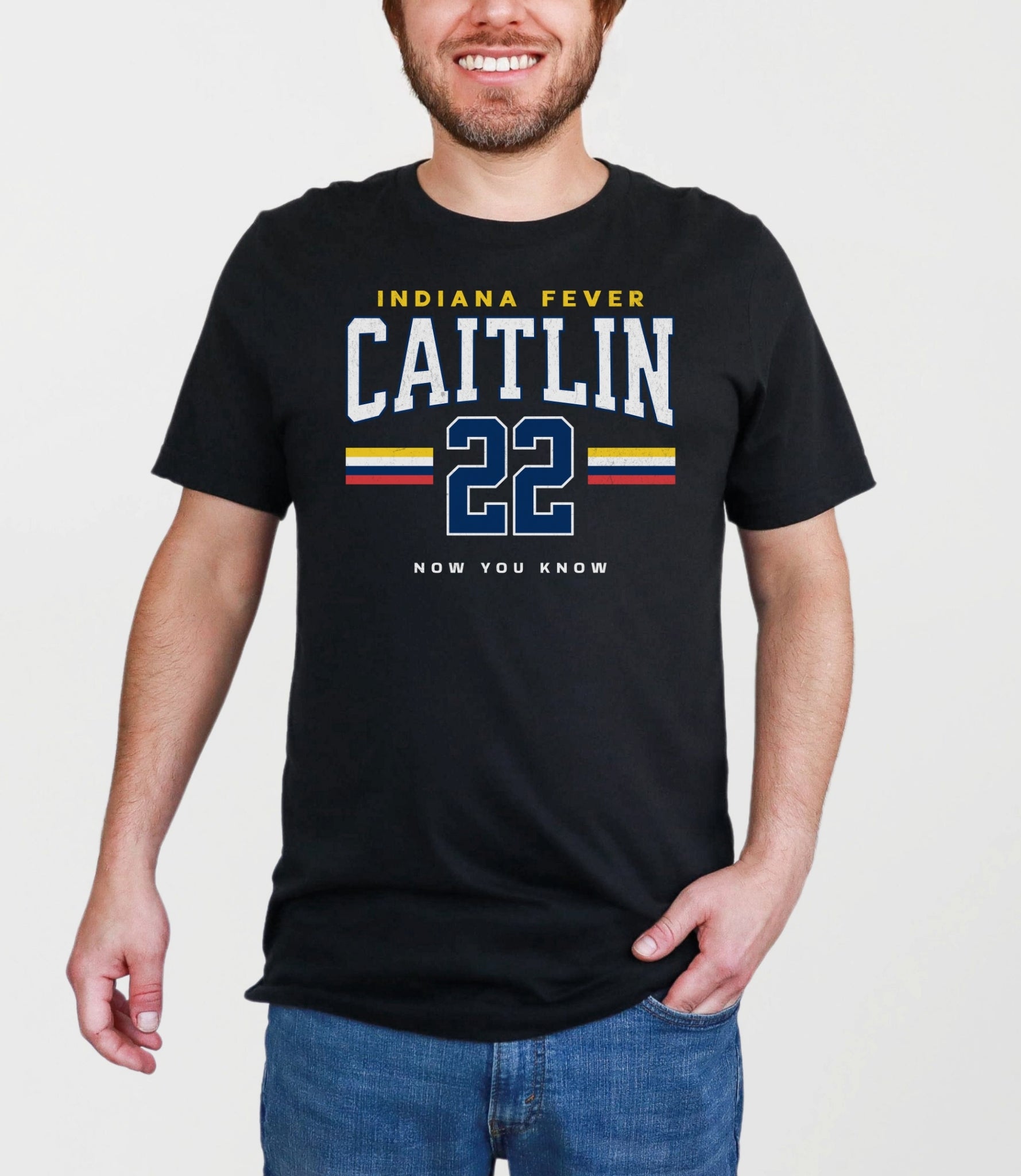 Person wearing a black t-shirt with 'Indiana Fever Caitlin 22' text on a plain background