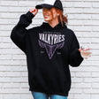 Person wearing a black hoodie with 'Golden State Valkyries' logo against a white brick wall.