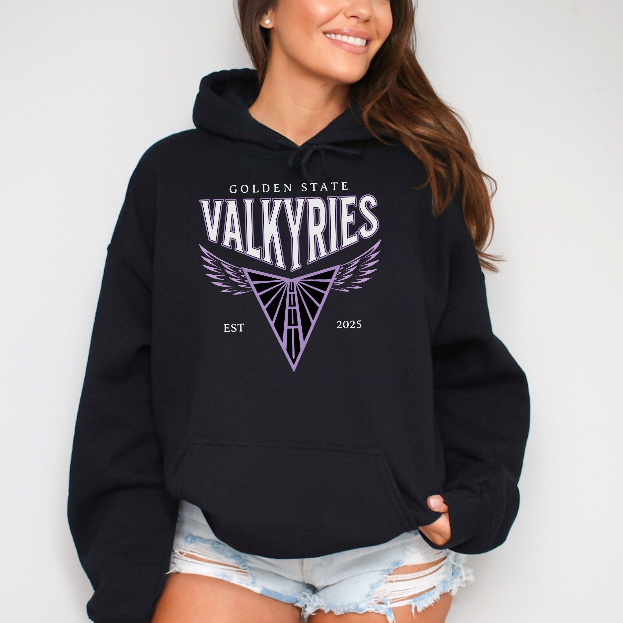 Person wearing a black hoodie with 'Golden State Valkyries' logo on a white background