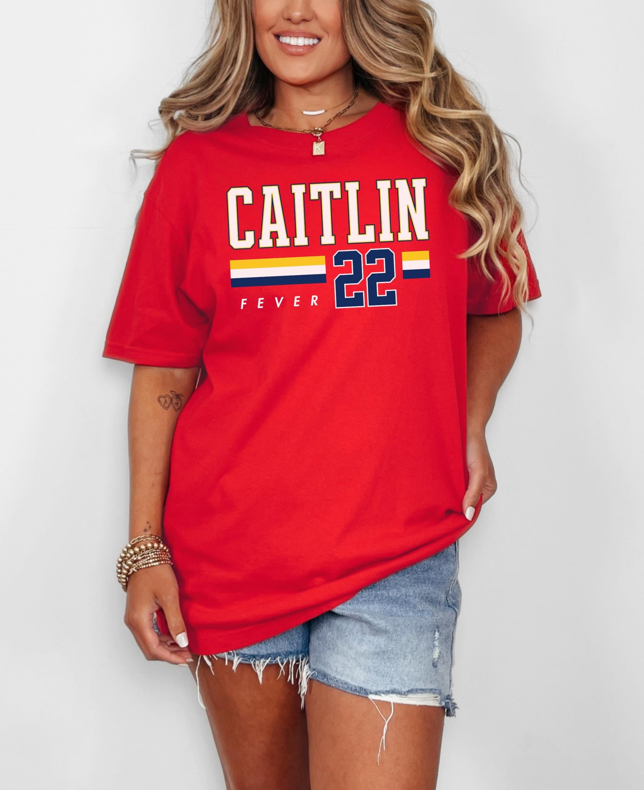 Person wearing t-shirt with 'CAITLIN FEVER' printed on it
