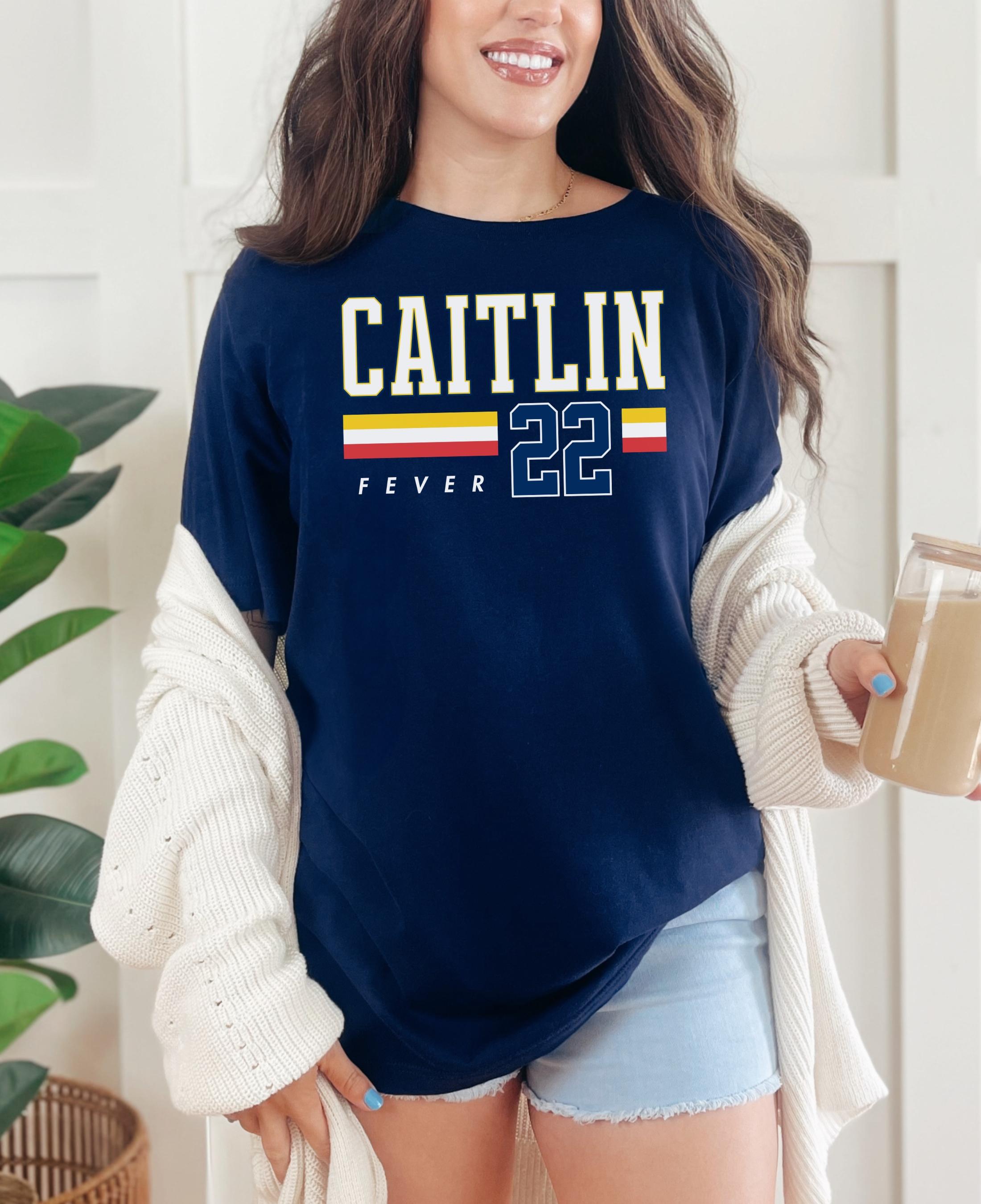 Person wearing t-shirt with 'CAITLIN FEVER' printed on it