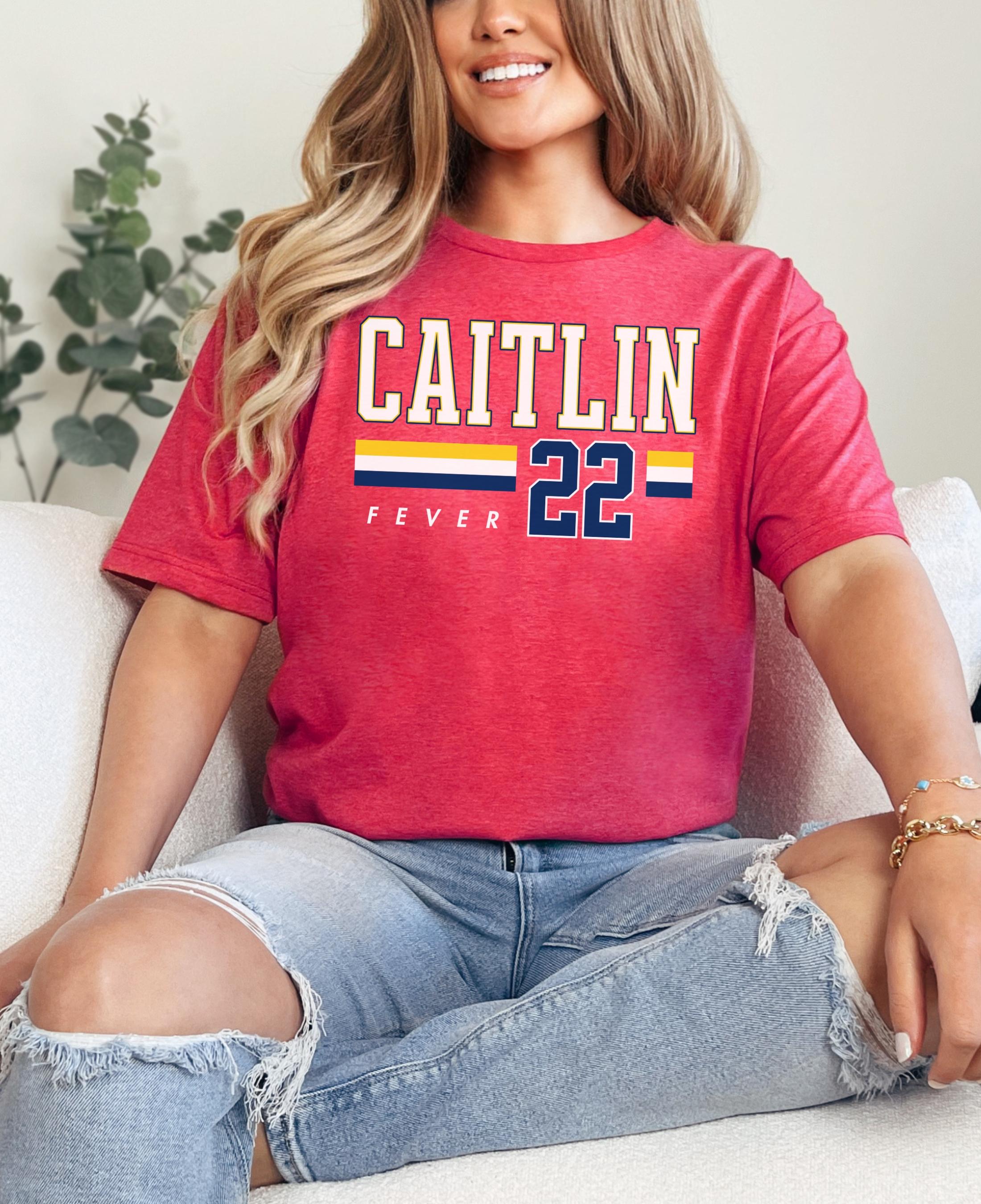 Person wearing t-shirt with 'CAITLIN FEVER' printed on it
