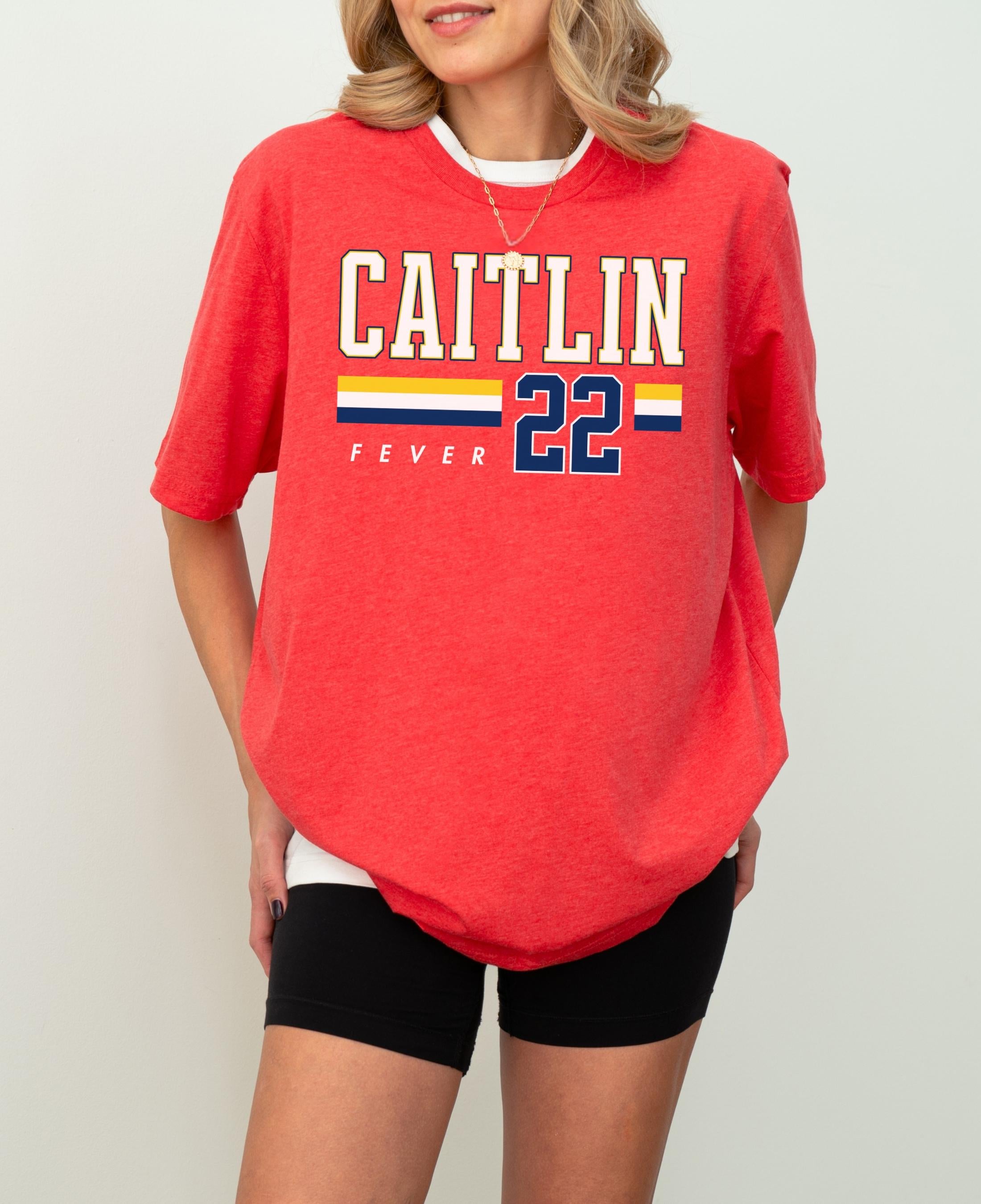 Person wearing t-shirt with 'CAITLIN FEVER' printed on it