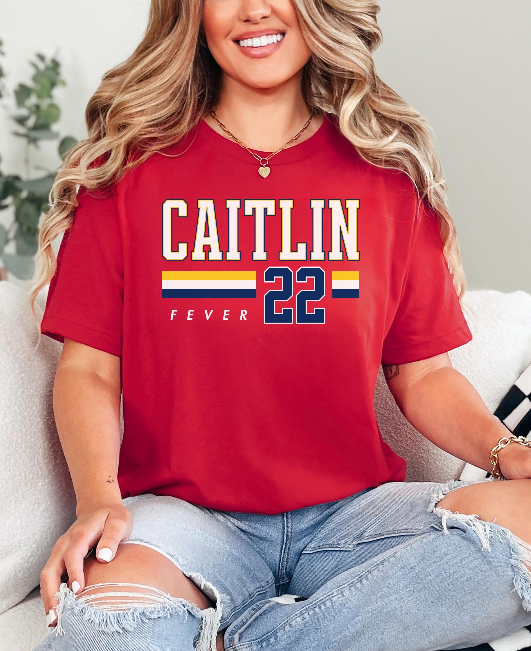 Person wearing t-shirt with 'CAITLIN FEVER' printed on it
