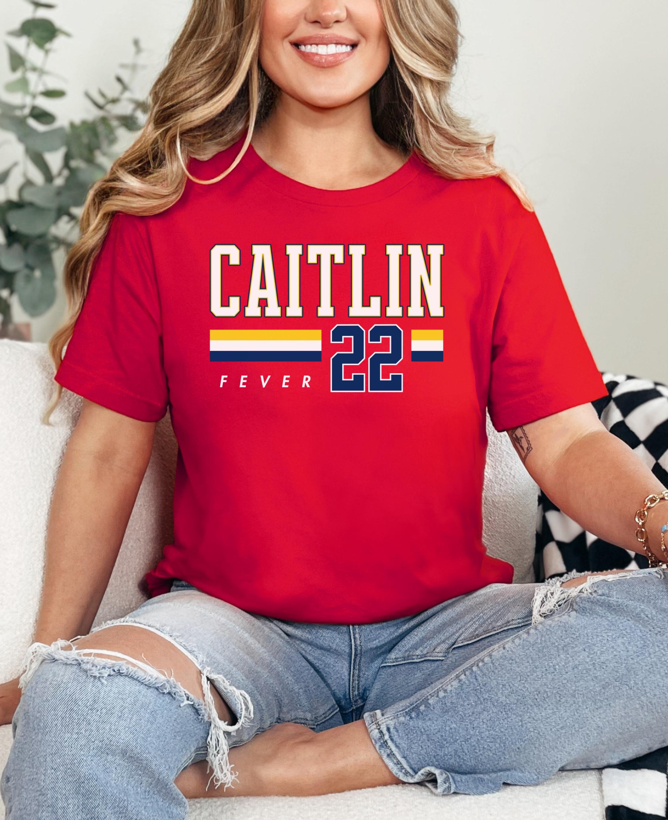Person wearing t-shirt with 'CAITLIN FEVER' printed on it
