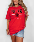 Person wearing a red 'Portland Fire' t-shirt on a white background
