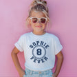 Child wearing a white t-shirt with 'Sophie 8 Fever' design against a pink background