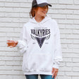 Person wearing a white hoodie with 'Golden State Valkyries' logo against a brick wall.