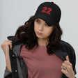 Girl wearing black number 22 dad hat